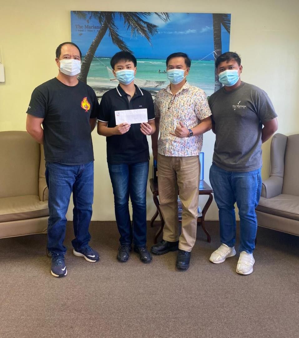 Leyonne  Tolentino,  second  left,  is  awarded  3rd place  on  June  4,  2021  in  the  Marianas  Visitors  Authority's  Tourism  Month  essay  contest.    From  left,  MVA community  projects  manager  Martin  Duenas,  Tolentino,  his father Rowell D.  Tolentino,  and MVA community projects specialist Jack Aranda.