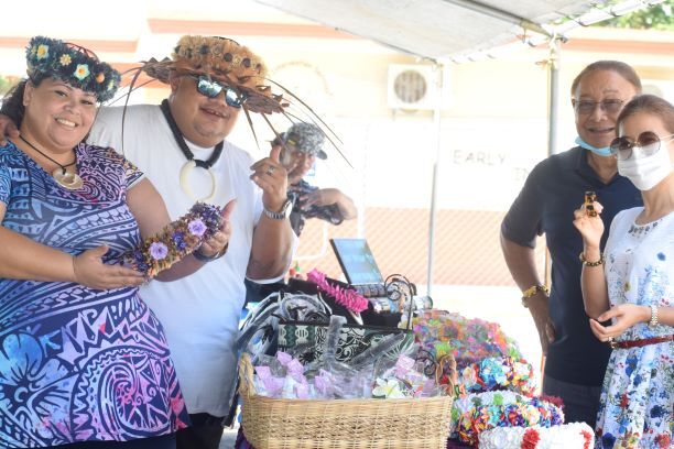 Norman Rasiang and Aofia Tuiolosega sells local crafts to Acting Commerce Secretary Edward "Tofila" Deleon Guerrero and wife Lina.