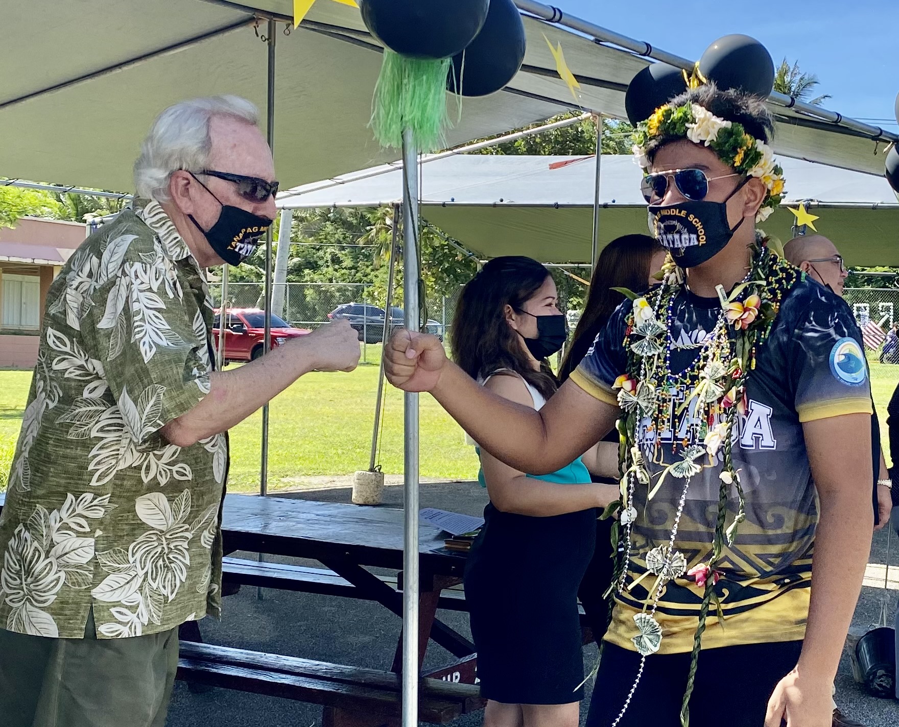 PSS Federal Programs Officer Tim Thornburgh fist bumps a promoted student.