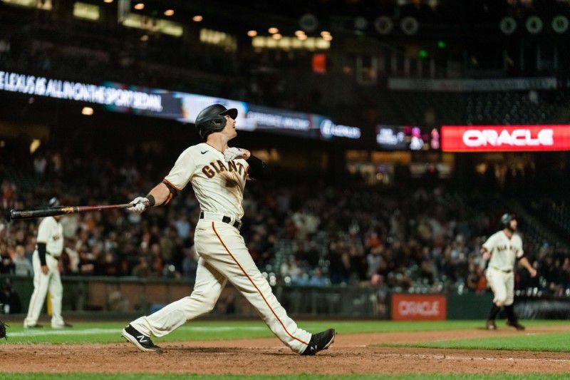 San Francisco Giants right fielder Mike Yastrzemski (5) watches the ball clear the wall after hitting a grand slam against the Arizona Diamondbacks in the eighth inning at Oracle Park in San Francisco on Tuesday.