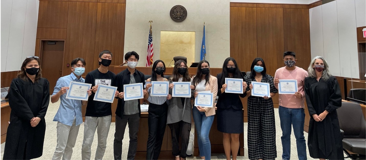 Chief Judge Ramona V. Manglona, left, and Magistrate Judge Heather L. Kennedy, right, with the winners of the video contest:         John San Nicolas, Seungwoo Lee, Skyler Poon, Connie Zhu, Katherine Avendaño-Woodruff, Brandee Hunter, Vivien Liu, Janalene Imperial and Jigger Parayaoan.