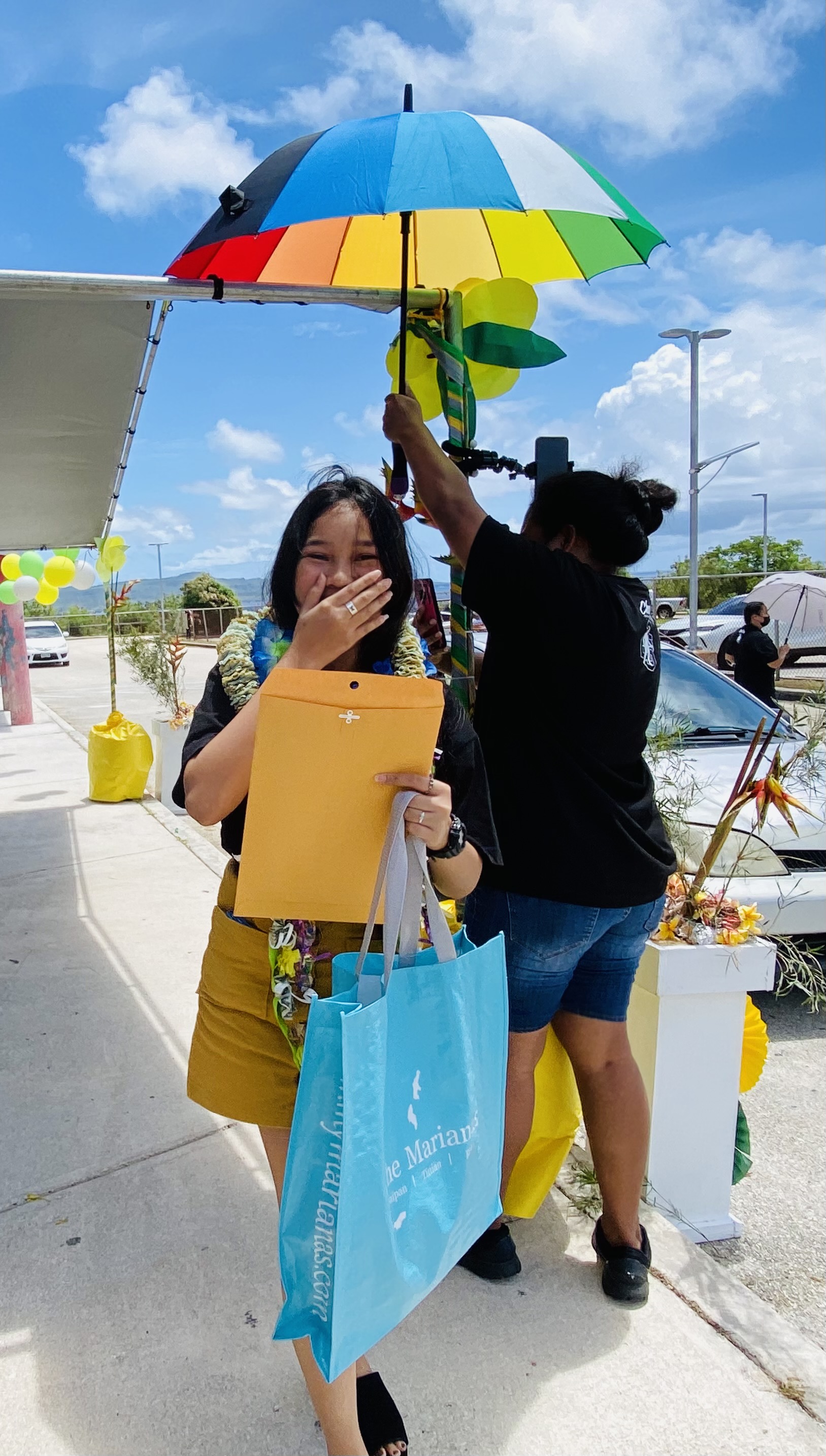 An eighth grader smiles upon receiving her certificate of promotion and a bag of gifts from Tan Siu Lin Foundation and Chacha Oceanview Middle School.