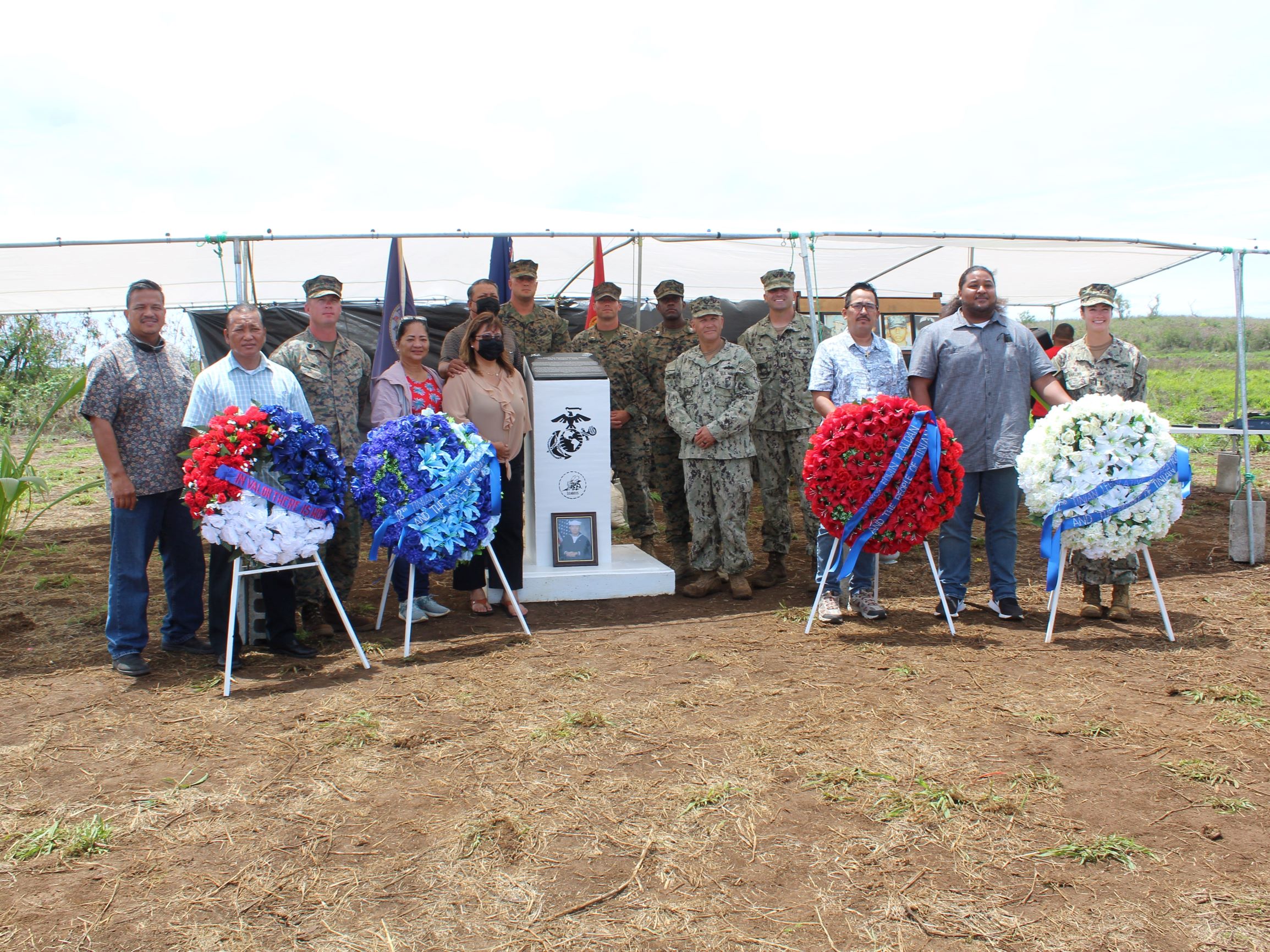 The Marines of Charlie Company pose for a photo with Tinian Mayor Edwin Aldan and other elected officials next to the memorial monument on Kastiyu Plateau.