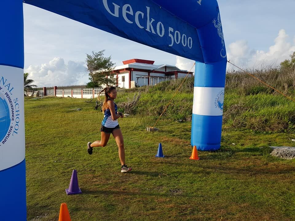 Tania Tan crosses the finish line of the June Underground 5K race at  Banzai Cliff on Saturday.