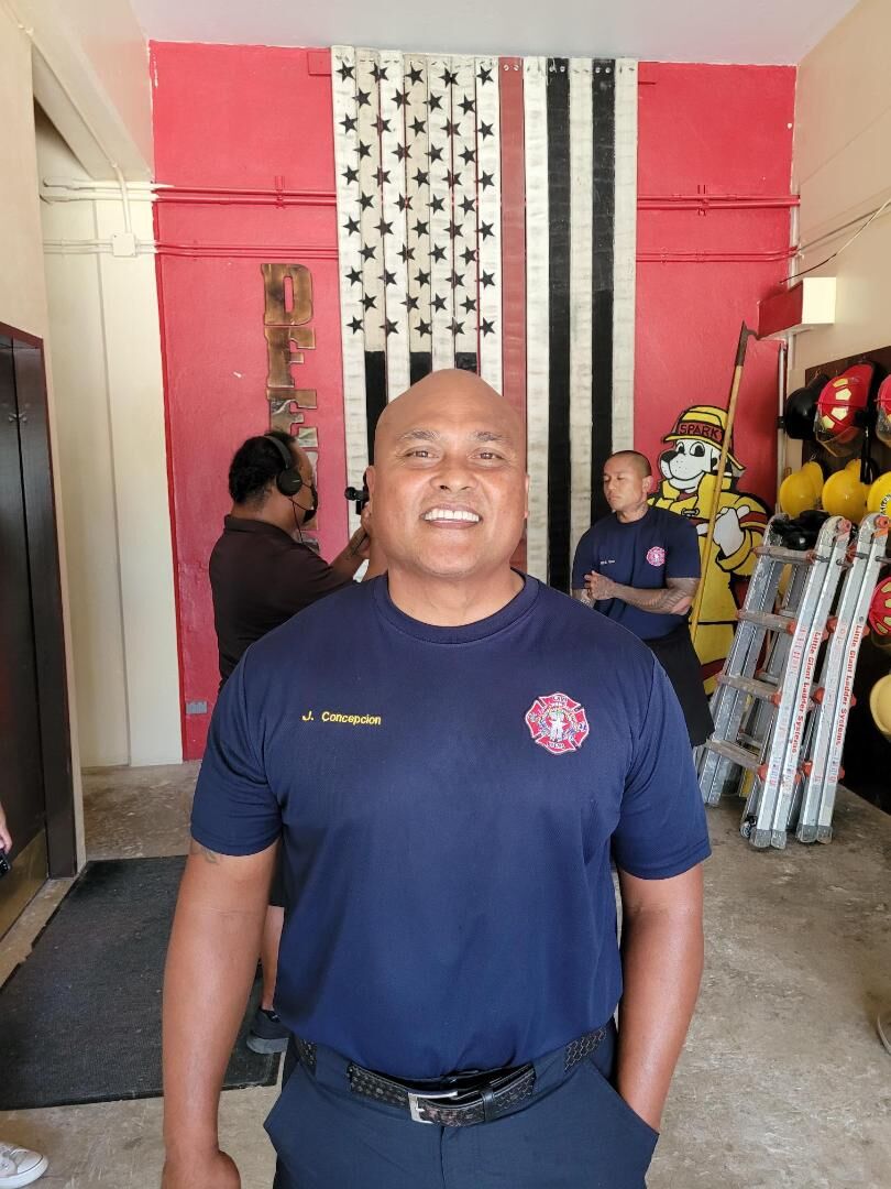Fire department training coordinator JJ Concepcion smiles for Variety. Also in photo, right background, is senior drill instructor Robert Cruz at the department's training center on Capital Hill Tuesday