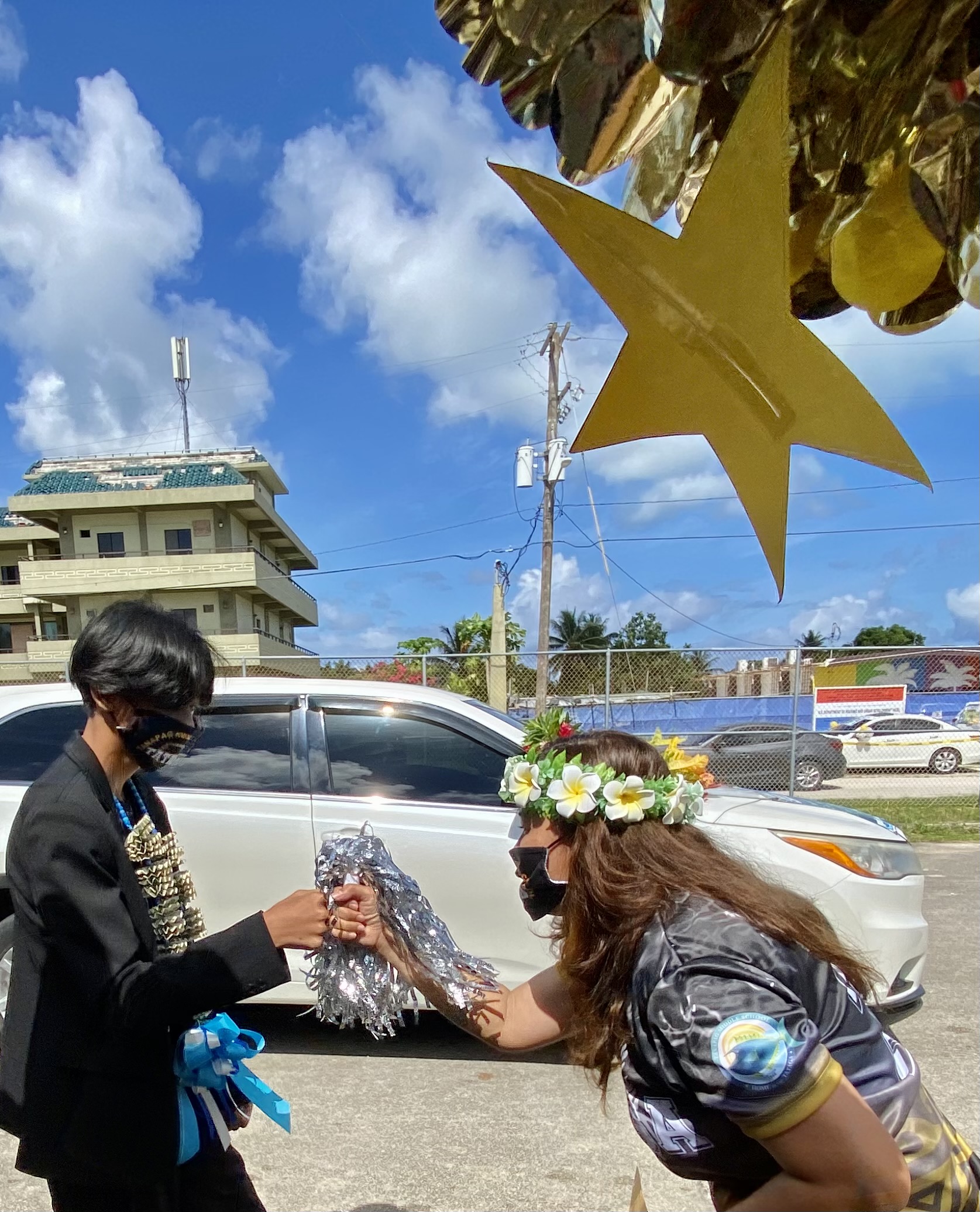 Tanapag school principal Hilda Rios congratulates one of her promoted students.