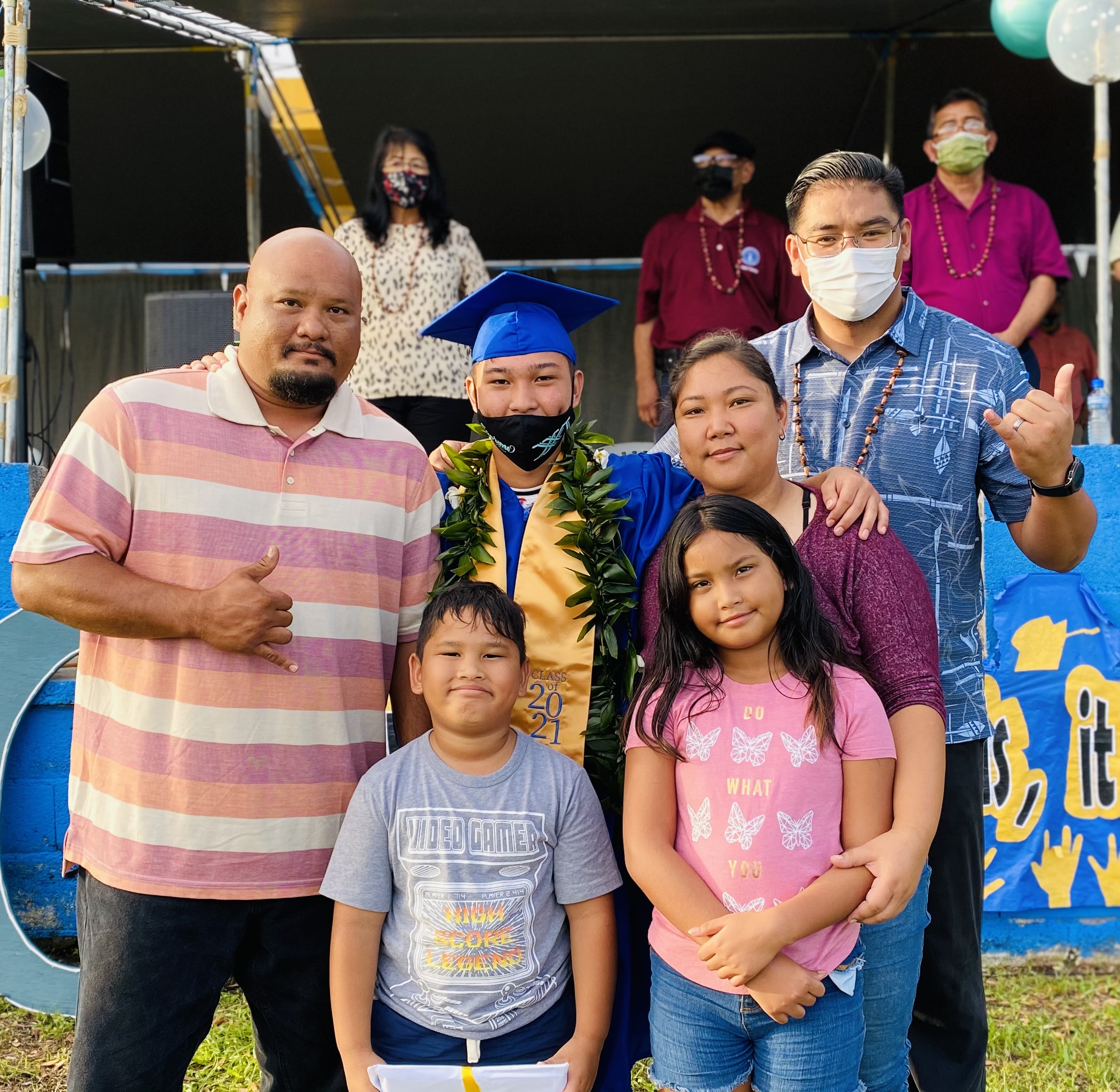 RHI  graduate Logan Taitano and his family with BOE member Antonio L. Borja. In the background are Sen. Teresita Santos, BOE Vice Chairman Herman Atalig and Rota Mayor Efraim Atalig.