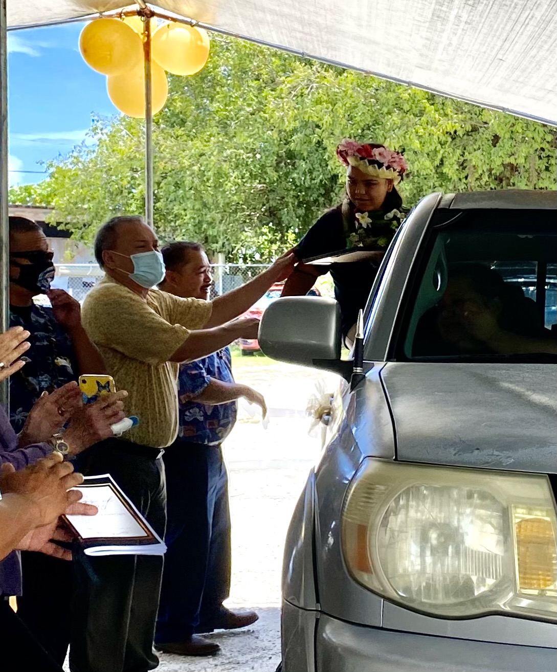 A student receives his certificate of promotion from education officials.