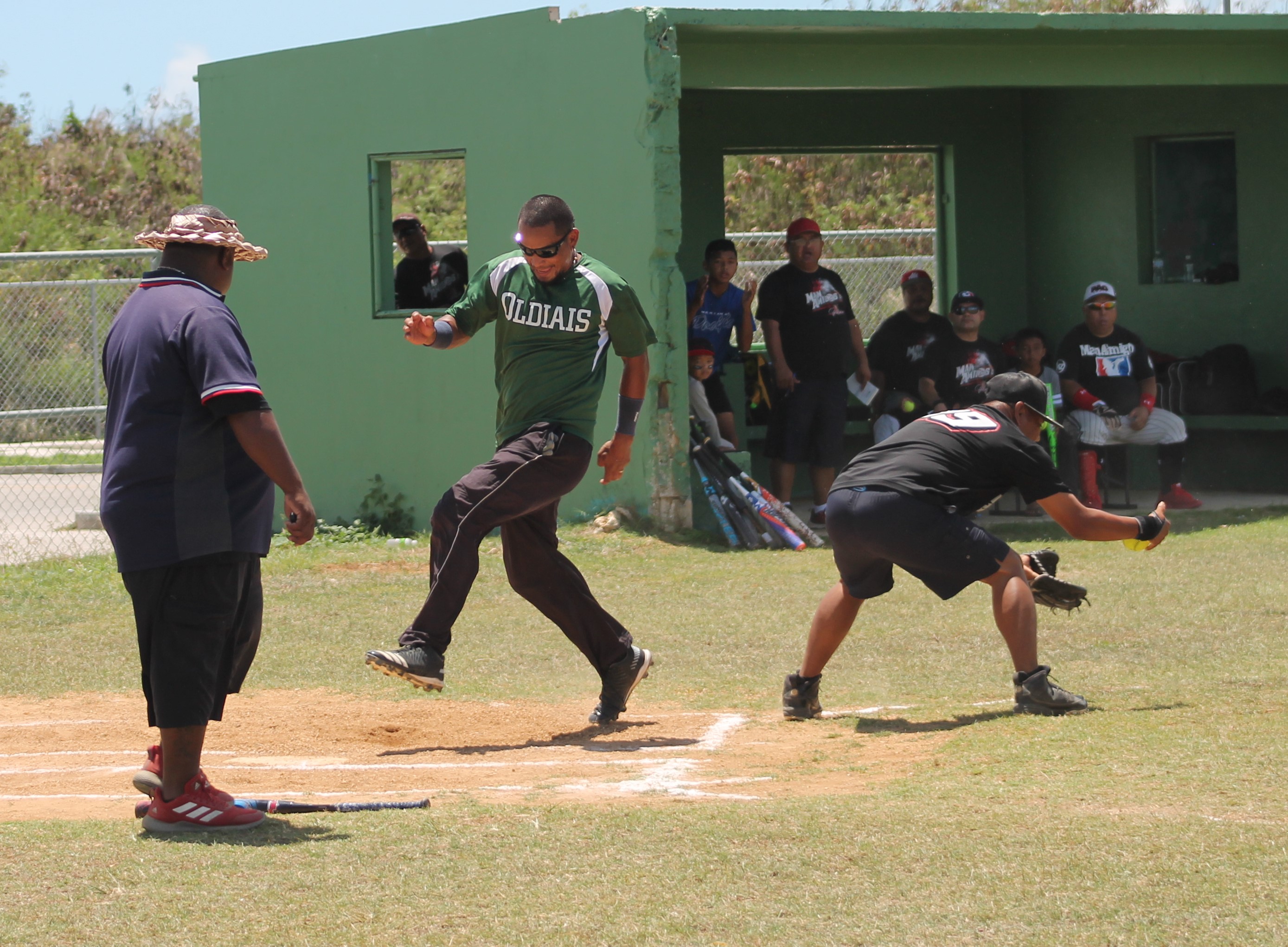 PeLeLiu's Cartfield Sablan reaches home base during the championship game of the Belau Amateur Softball League on Sunday at the Dandan baseball field.