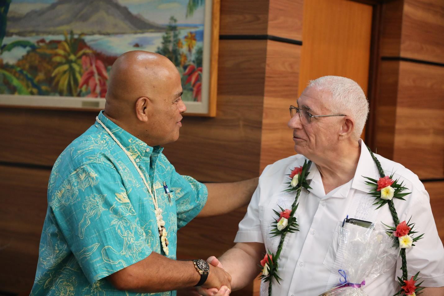 FSM President David W. Panuelo shakes hands with USAID country coordinator Rodger Garner who, like Panuelo, has a special connection with the U.S. State of Oregon.
