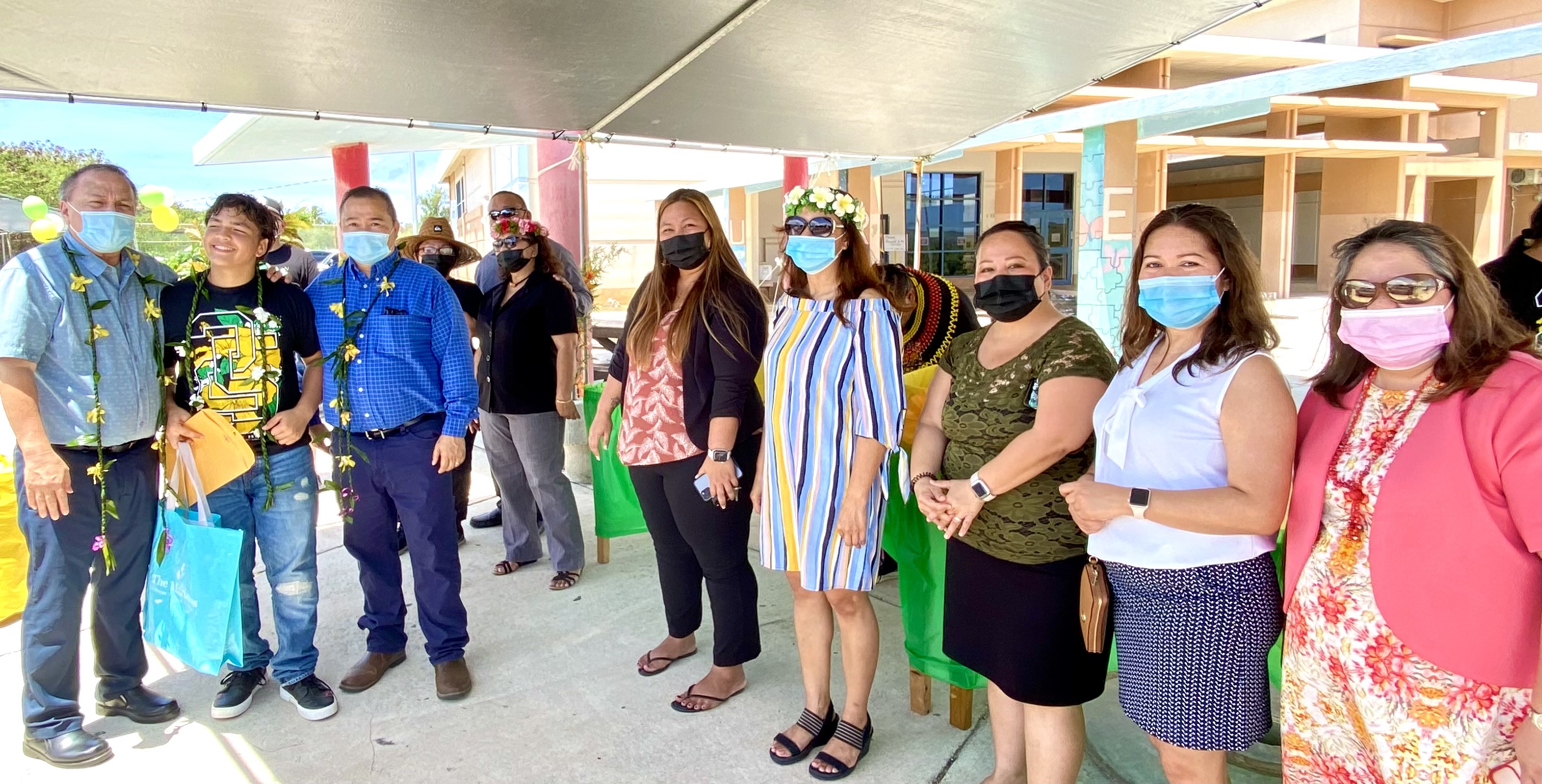 Board of Education Chairman Andrew Orsini, Commissioner of Education Dr. Alfred Ada, Chacha principal Martha Kintol, vice principal Leah Murphy and the school district’s other officials congratulate Mametto Maratita Iakopo on his promotion to high school.