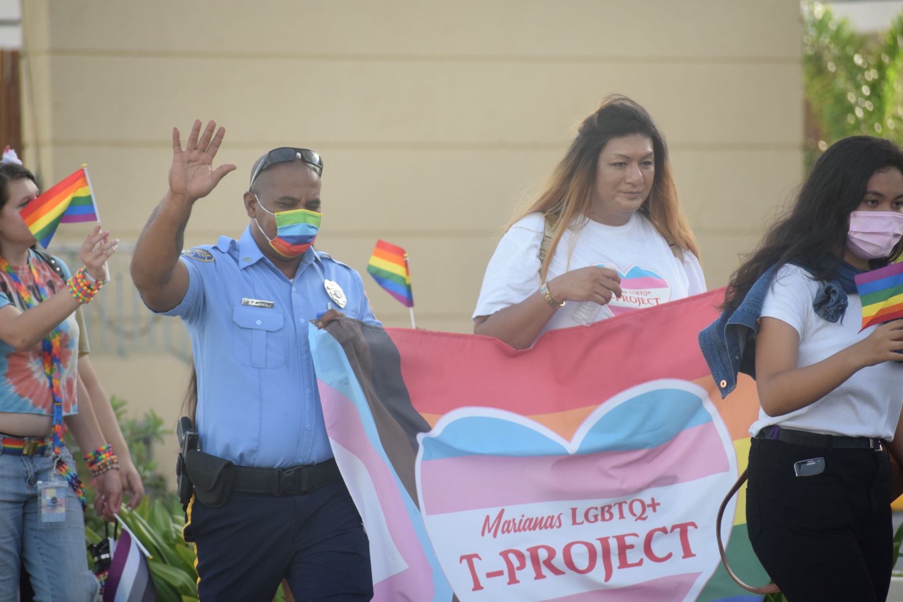 Police Officer Patrick "China Man" Arriola and T-Project founder Tyra Lyn Sablan, 2nd right, participate in the Stride for Pride parade.
