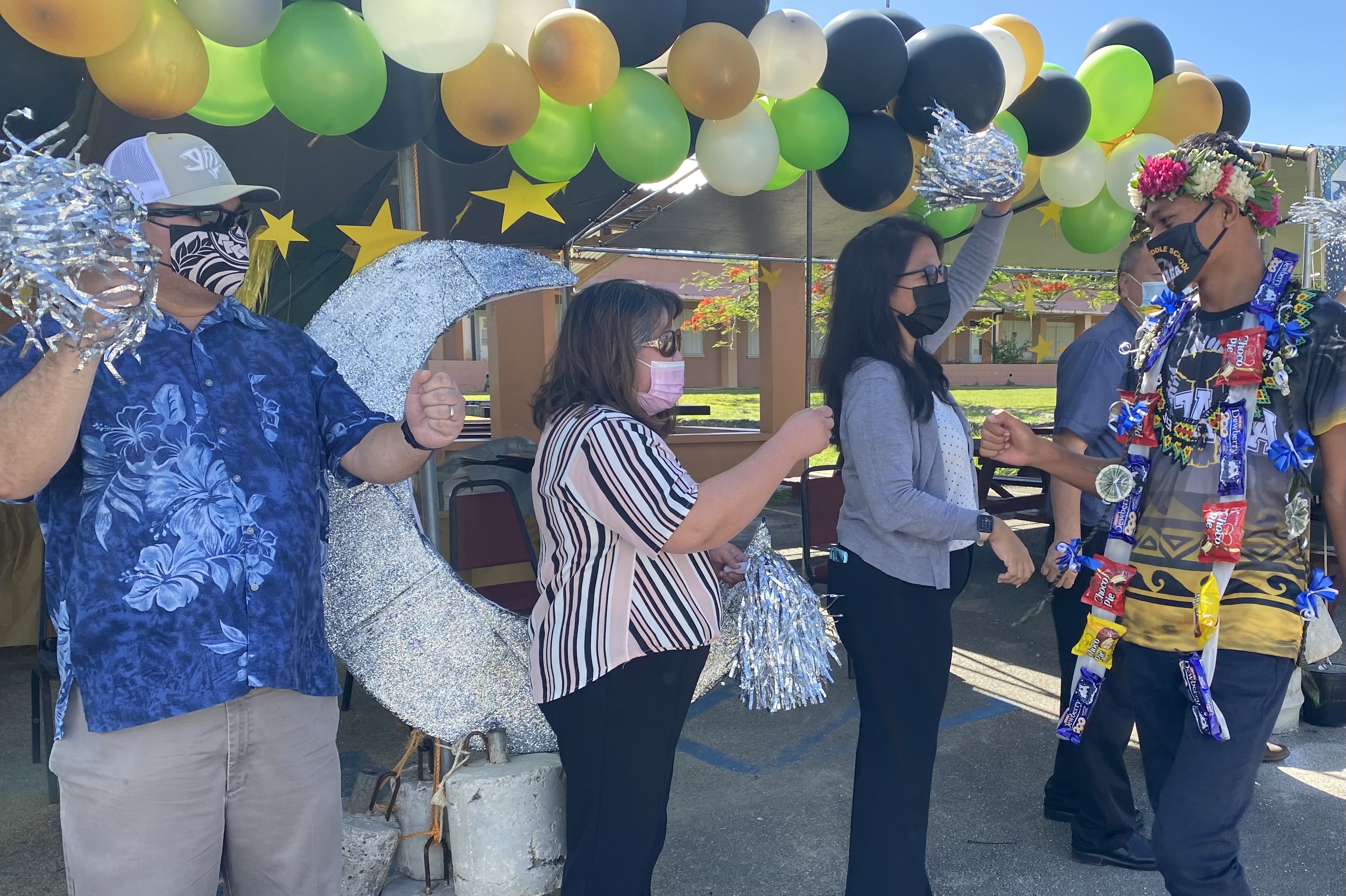 Hopwood principal Victorino Borja, PSS Senior Director Dr. Rizalina Liwag and Board of Education member Maisie B. Tenorio of Saipan congratulate a promoted student.