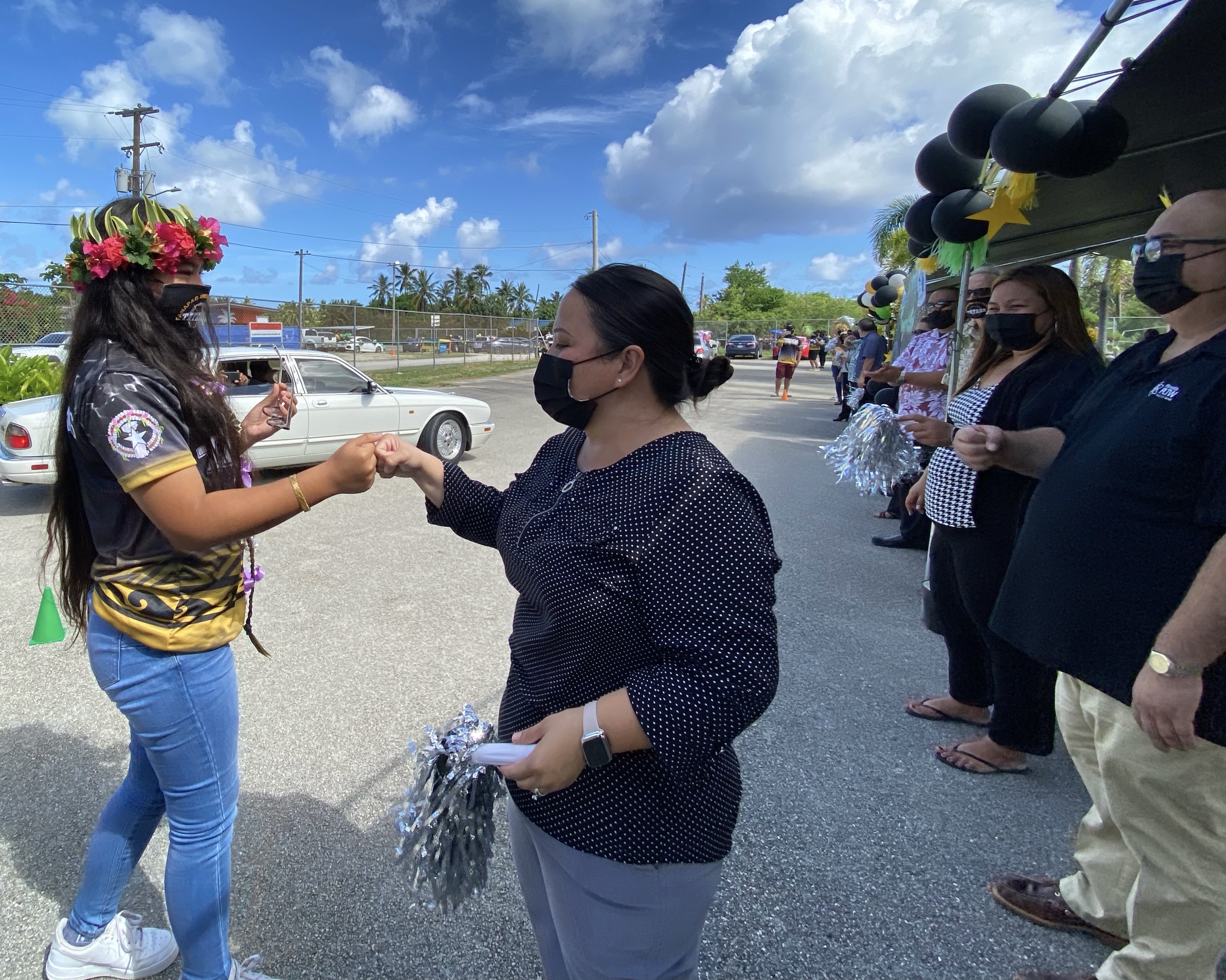 PSS Human Resources Officer Lucretia B. Deleon Guerrero fist bumps a promoted eighth grader.