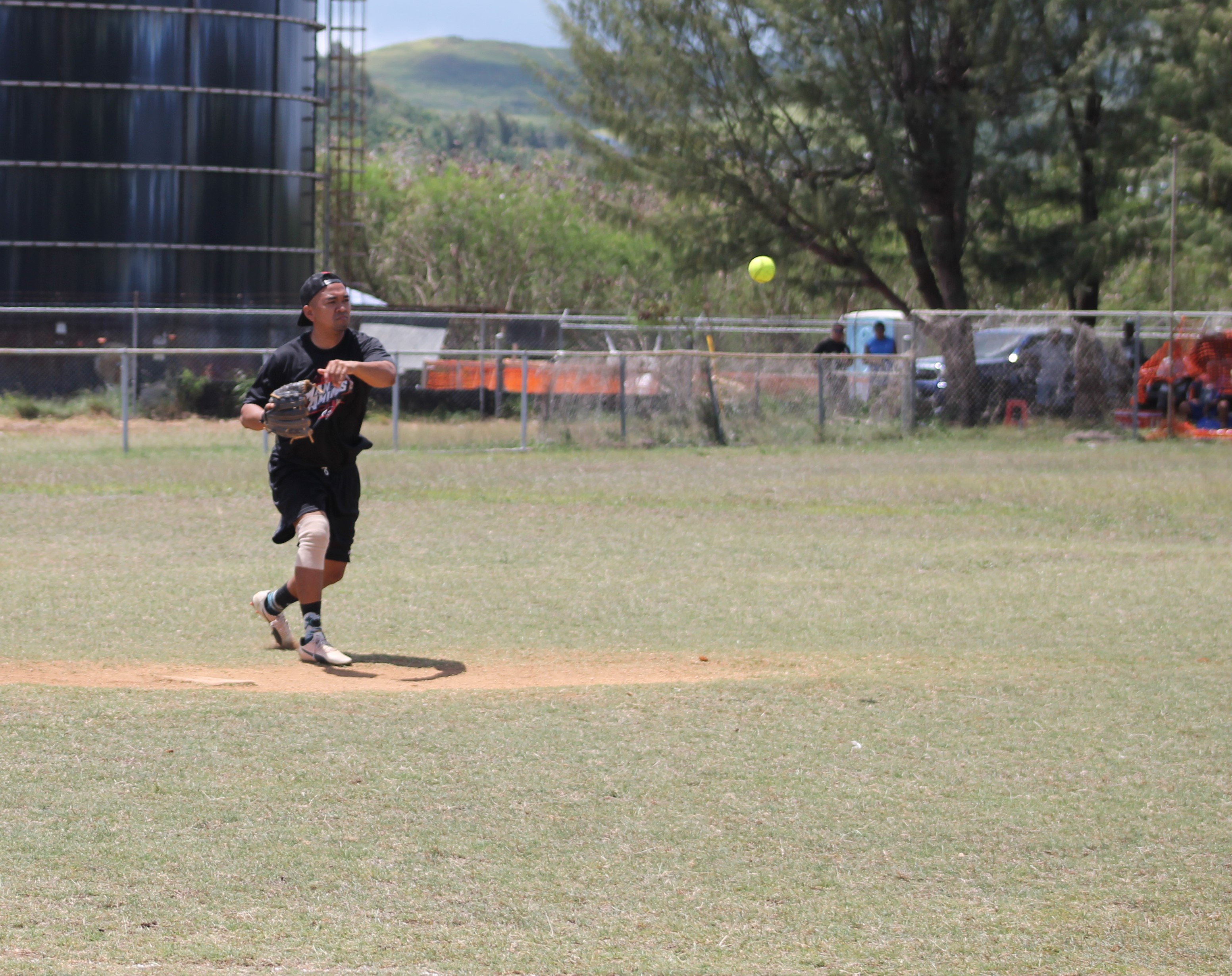 Man Amigos' pitcher Eric Palacios throws to first base for the out.