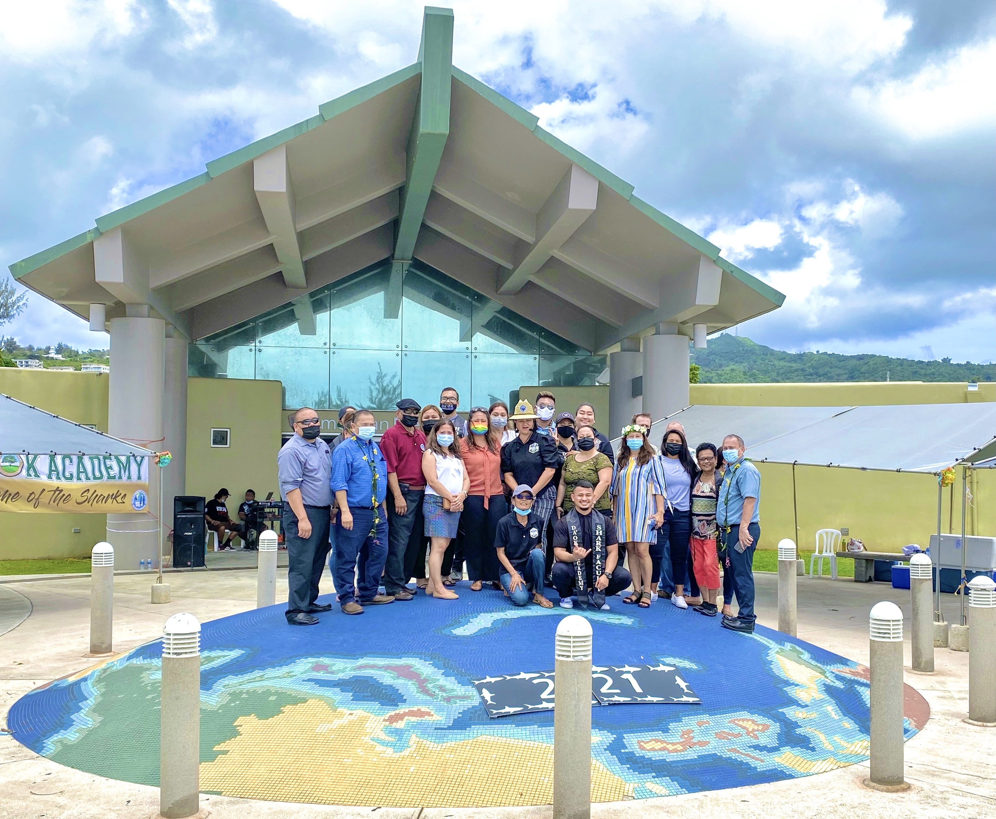 Education and CNMI officials pose for a photo following the graduation ceremony.