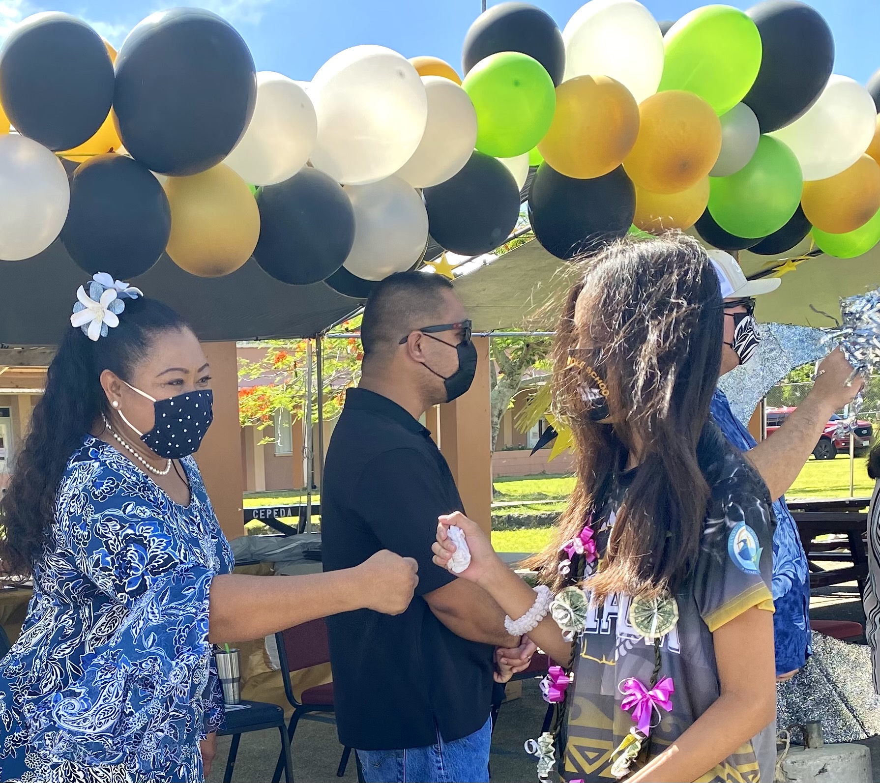 Francisco M. Sablan Middle School principal Cherlyn Cabrera Osung and PSS Infrastructure Technology Director Jesse Tenorio congratulate promoted students.