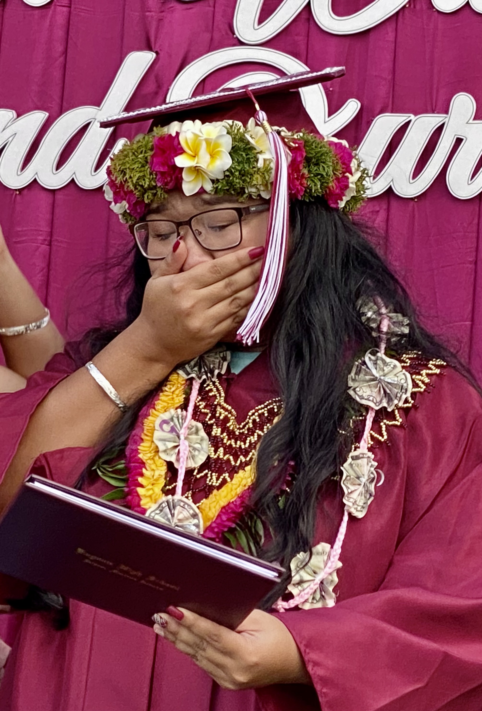 A new graduate gets emotional after receiving her diploma.