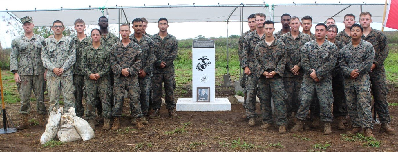 Members of the Charlie Company of the 7th Engineer Support Battalion, 1st Marine Expeditionary Force, 1st Marine Logistics Group stand next to the memorial monument on Kastiyu Plateau on Memorial Day,  May 31, 2021.