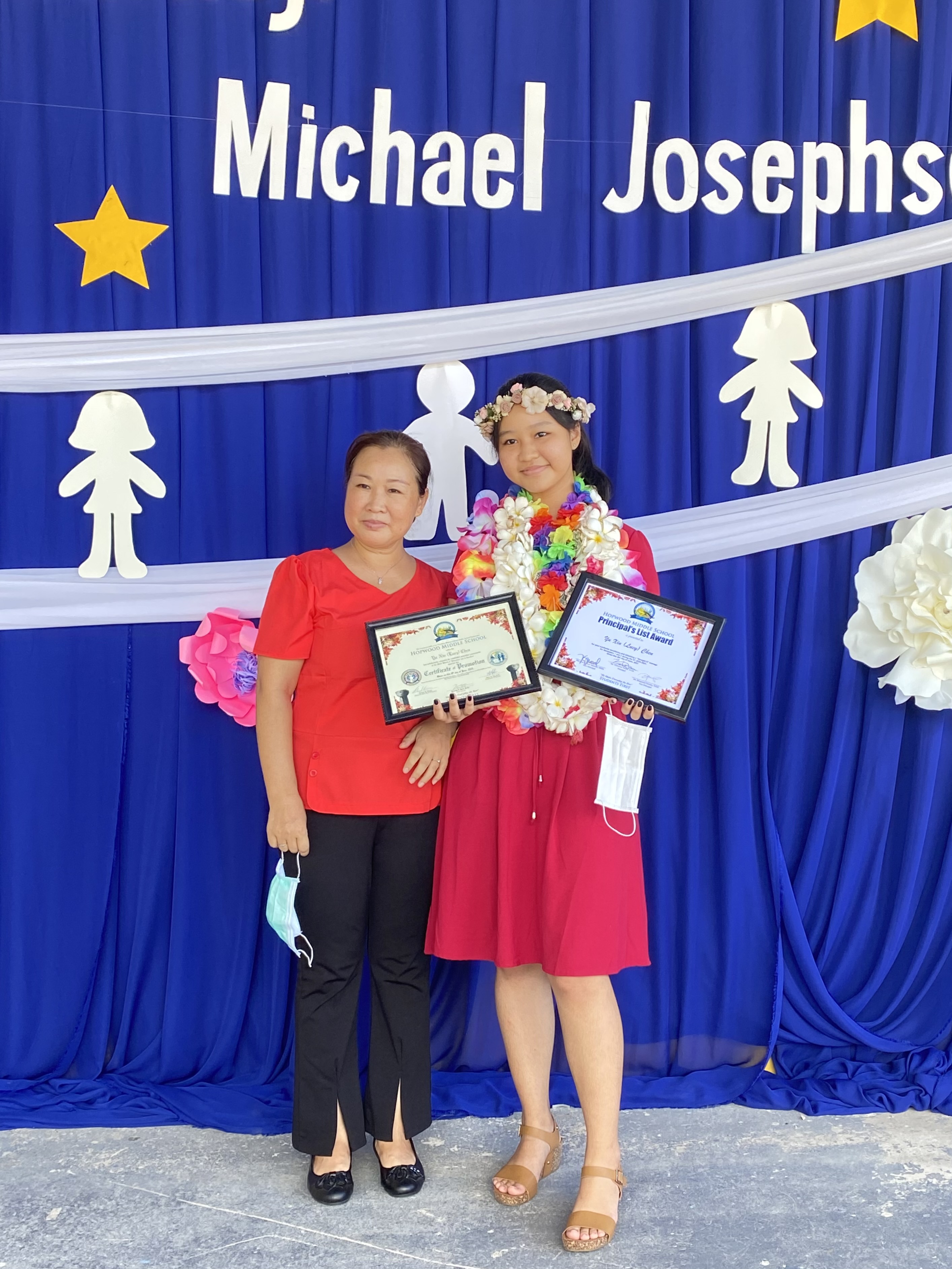 Promoted student Yu Xin Chen with her mother.  Yu Xin Chen received the Achive3000 Highest Lexile Award, IXL Mastery Award, Best in Mathematics Award, Best in Science Award, Best in English Language Arts Award, and Best in Career and Technical Education-Agriculture Award.
