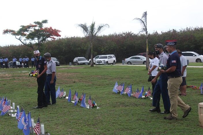 The Manta Ray Battalion cadets escort veterans who will place flowers on the gravestones.