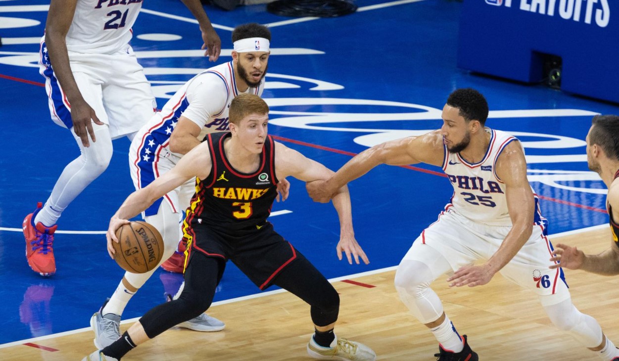 Atlanta Hawks guard Kevin Huerter (3) controls the ball against Philadelphia 76ers guard Ben Simmons (25) and guard Seth Curry (31) during the second quarter of game seven of the second round of the 2021 NBA Playoffs at Wells Fargo Center in Philadelphia, Pennsylvania on  June 20, 2021.