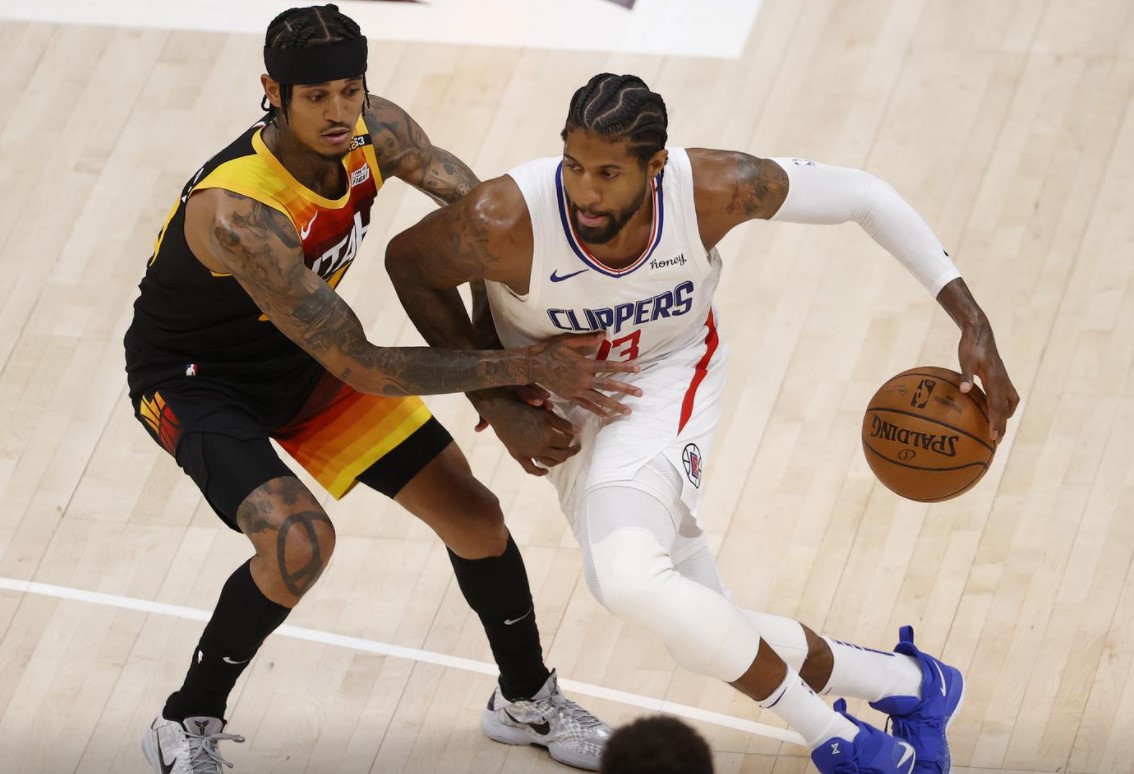 LA Clippers guard Paul George (13) drives against Utah Jazz guard Jordan Clarkson (00) in the fourth quarter during game one in the second round of the 2021 NBA Playoffs at Vivint Arena in Salt Lake City, Utah on June 8, 2021.