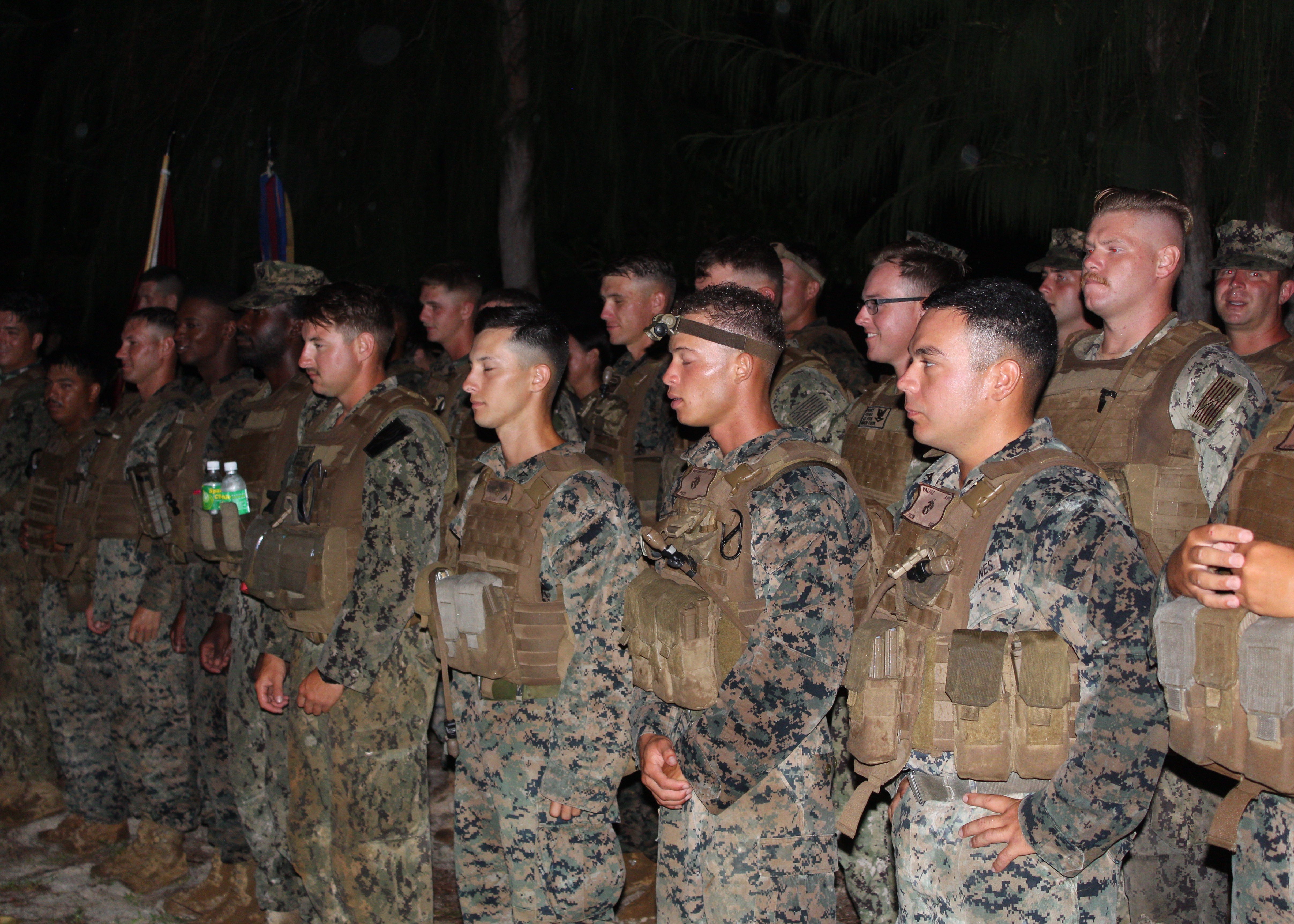 Members of the Charlie Company of the 7th Engineer Support Battalion, 1st Marine Expeditionary Force, 1st Marine Logistics Group gather on Kastiyu Plateau early in the morning in preparation for the memorial ceremony.