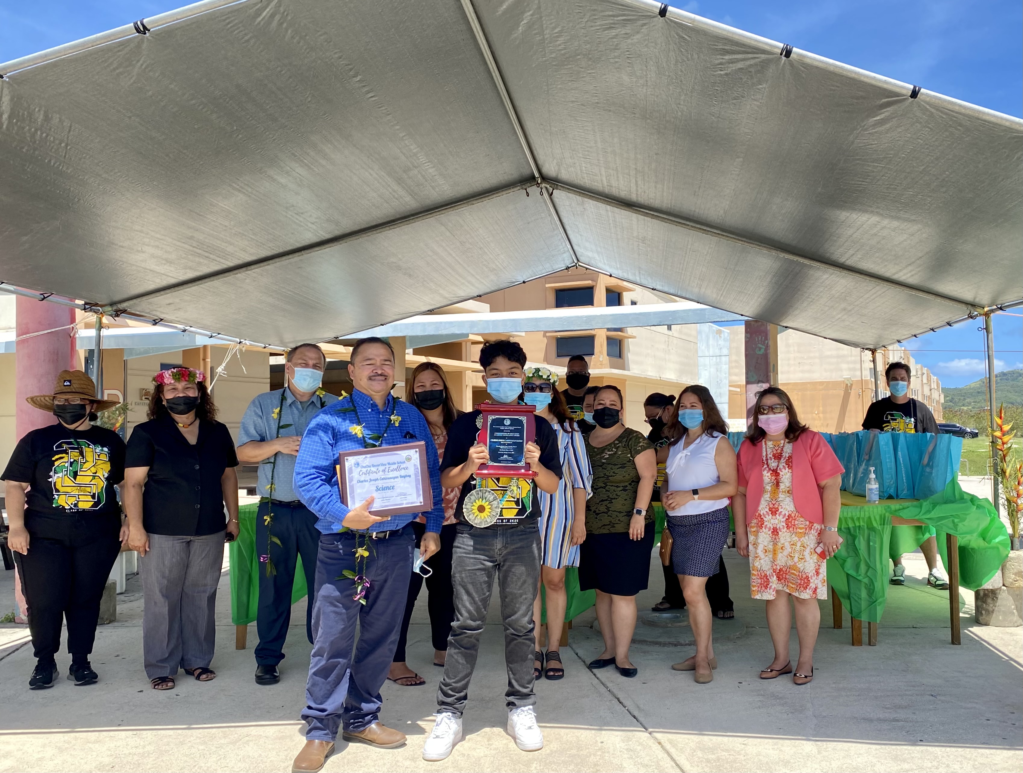 Charles Joseph Cahinusayan Baybay, Chacha Oceanview’s salutatorian, receives the Commissioner of Education Academic Achievement Award from the commissioner himself, Dr. Alfred B. Ada. Also in photo are Board of Education Chairman Andrew L. Orsini, Public School System Budget Director Arlene Lizama, Human Resources Officer Lucretia Borja-Deleon Guerrero, Head Start/Early Head Start Director Lathania Angui, Tanapag Middle School principal and middle school representative Hilda Rios.