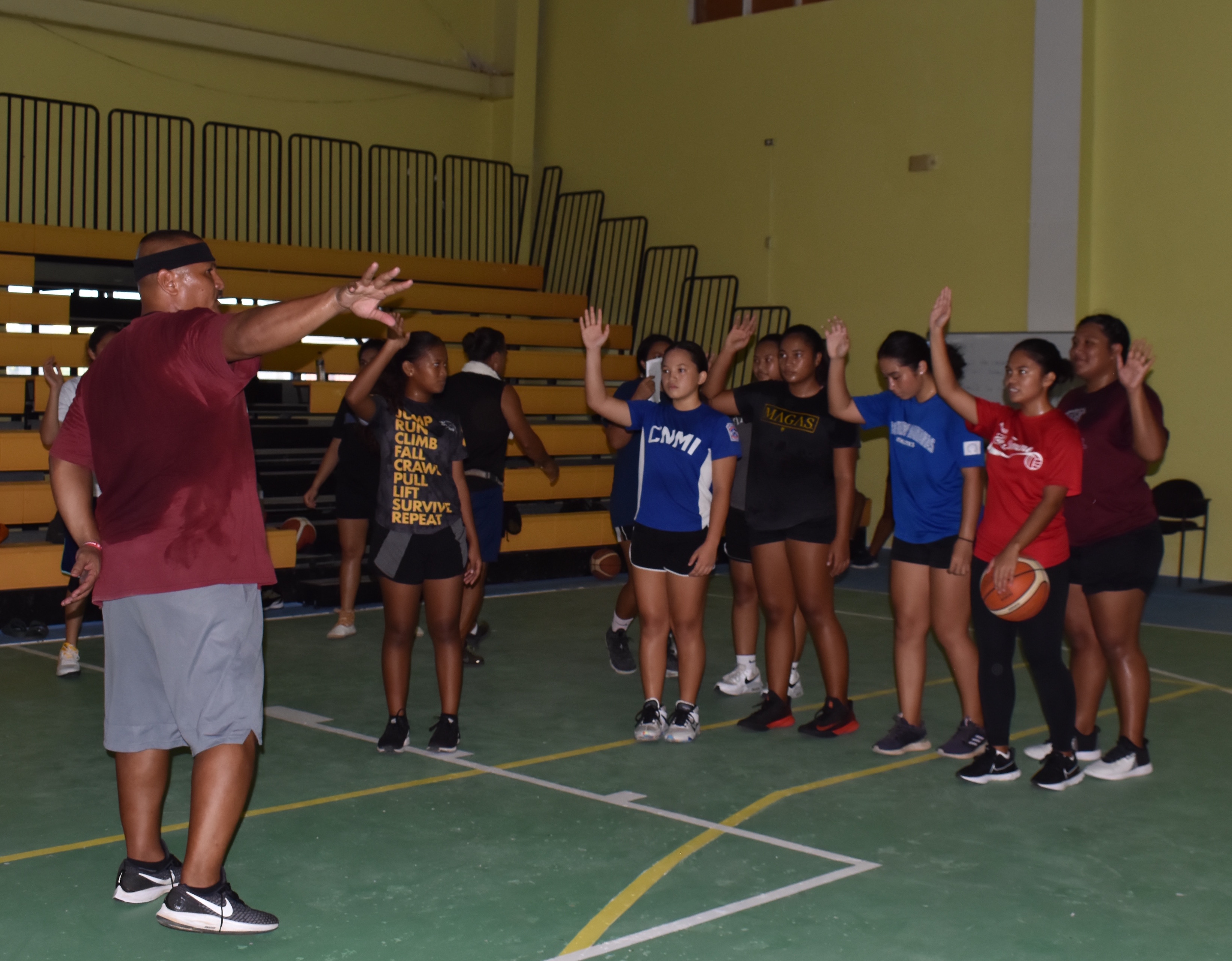 Volunteer coach John Santos instructs players to work by age groups during the Northern Mariana Islands Basketball Federation’s national program tryouts Tuesday night at the Gilbert C. Ada Gymnasium.