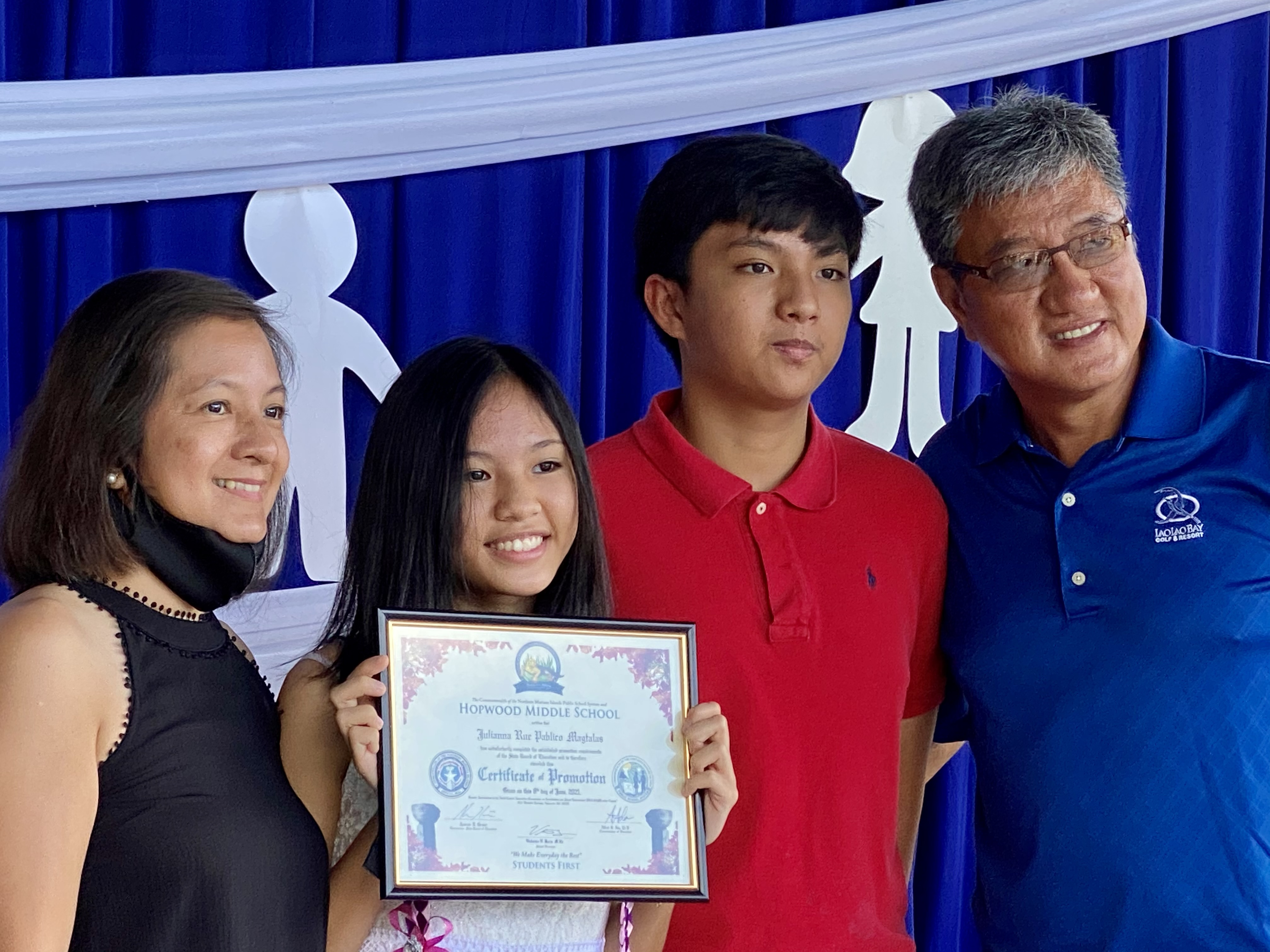 A promoted eighth grader with her family.
