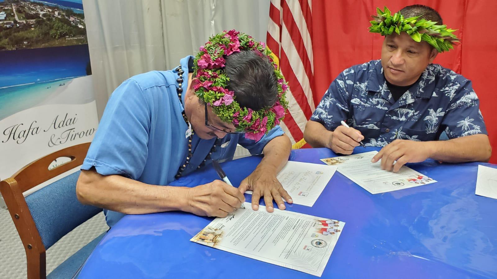 Mayor of Rota Efraim Atalig, left, and Chairman of the 18th Rota Municipal Council Jim M. Atalig sign the Hafa Adai & Tirow Pledge on June 21, 2021 at the Rota Mayor’s Office. The pledge program is open to all interested businesses, organizations, and individuals.