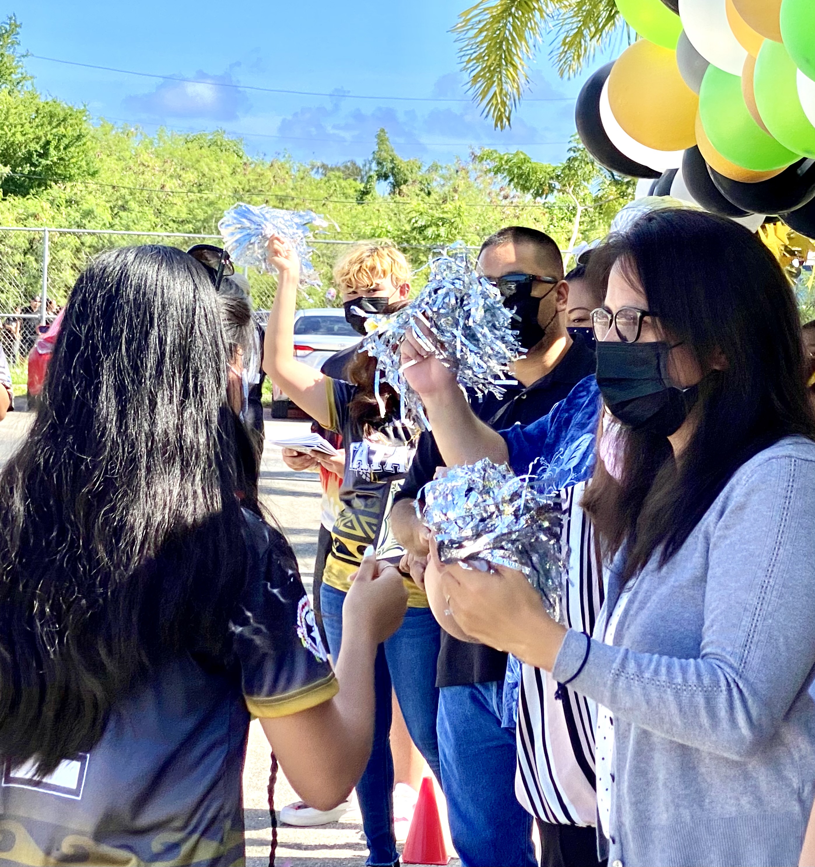 Board of Education member Maisie B. Tenorio of Saipan fist bumps an eighth grader of Tanapag Middle School during a promotion ceremony at TMS on June 4, 2021.