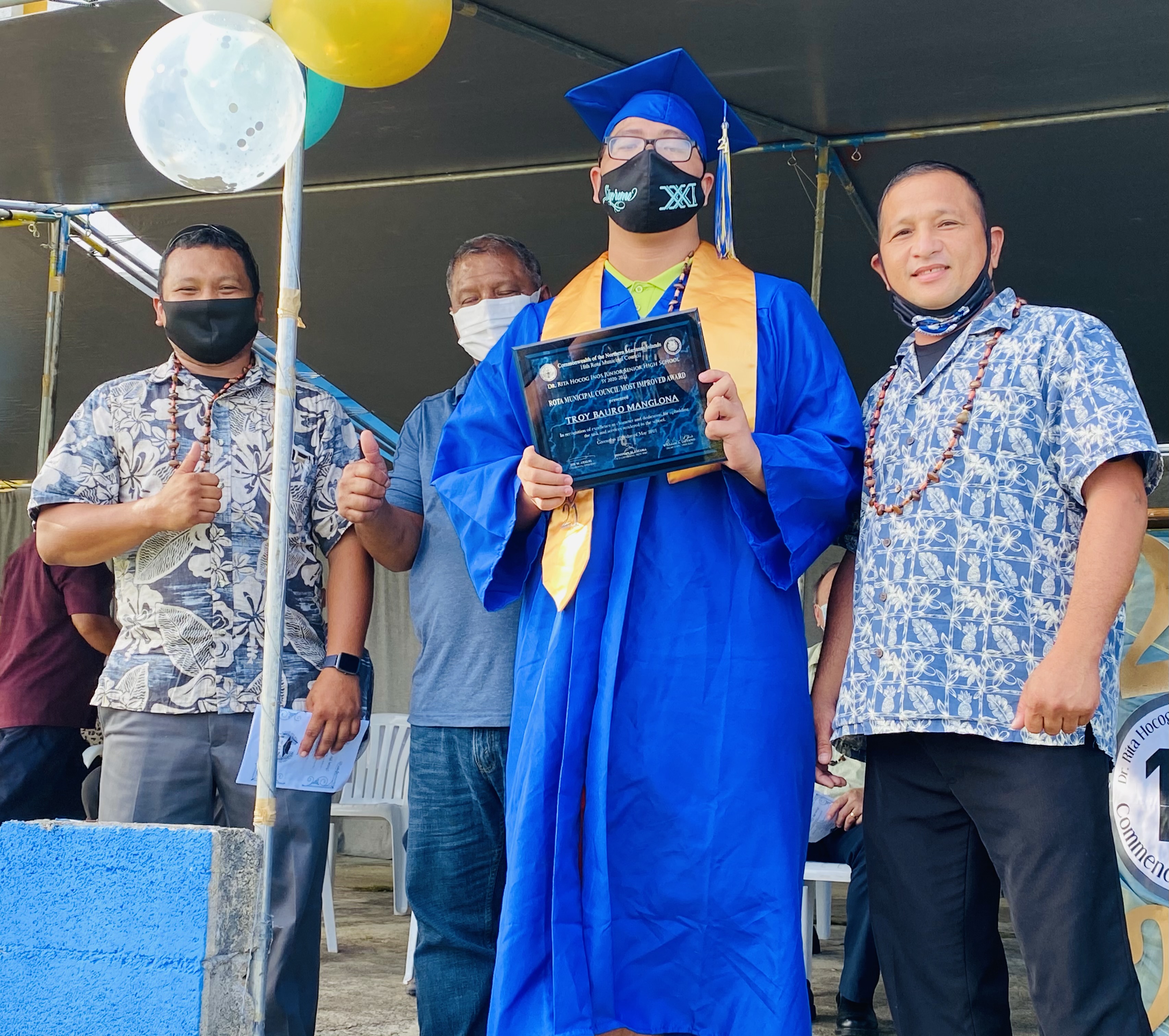 The Rota Municipal Council led by Council Chairman Jim Atalig, right, presented the Rota Municipal Council Award to Troy Bauro Manglona.