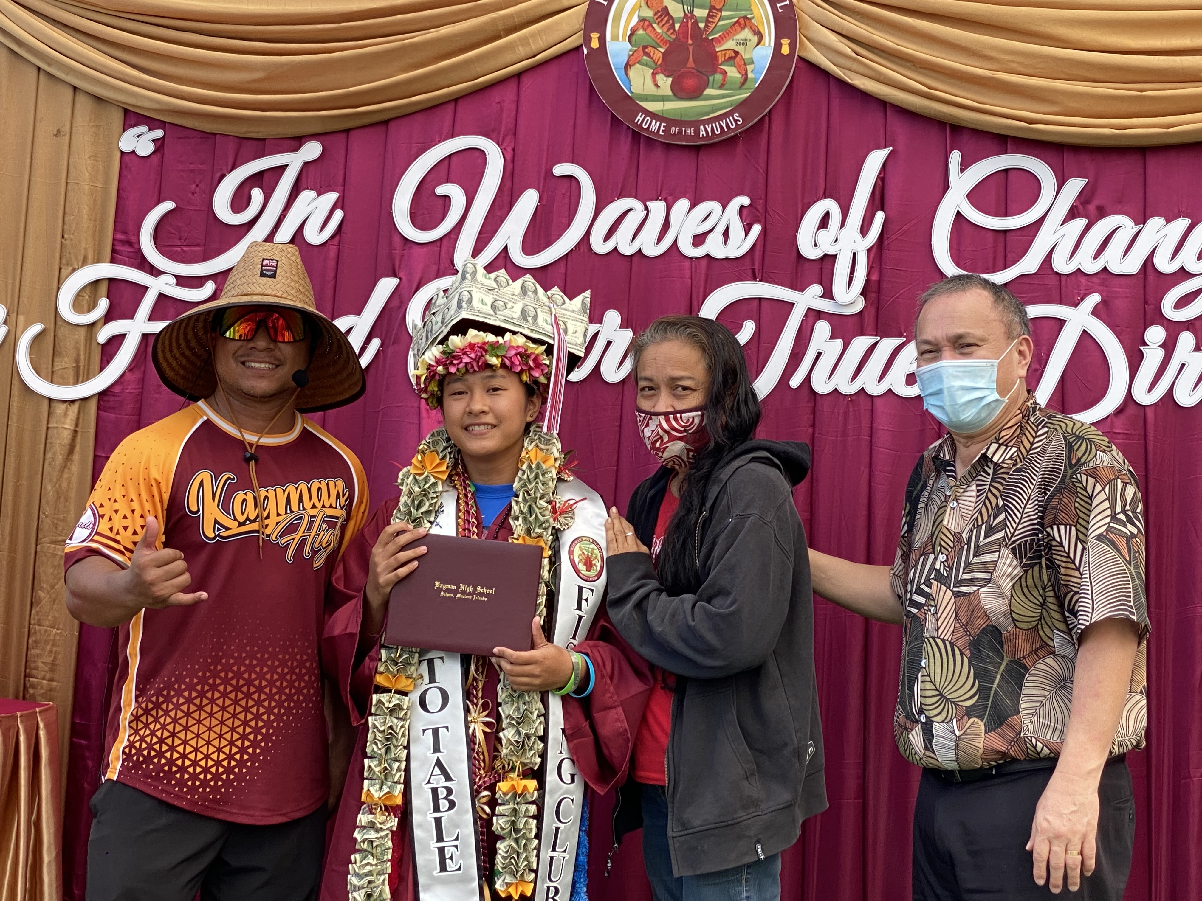 A graduate poses with her mother, school principal Ben Jones and BOE Chairman Andrew Orsini.