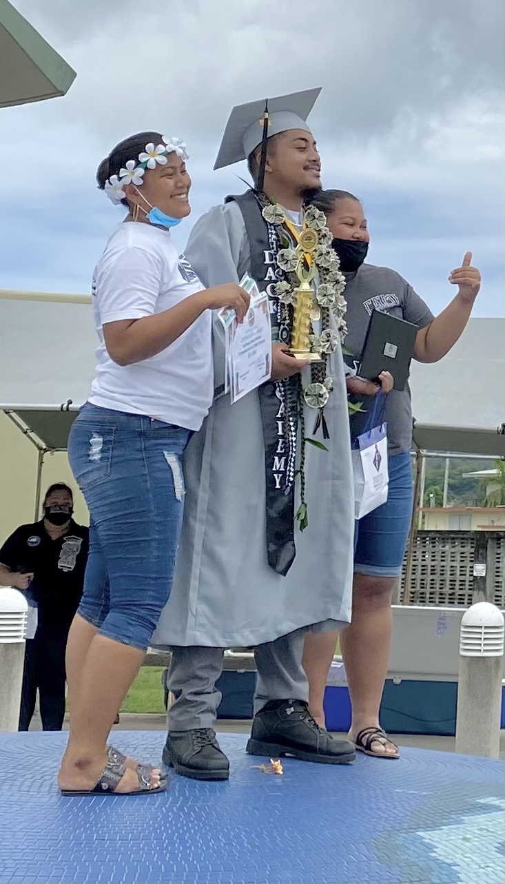 Another proud graduate poses with his family.