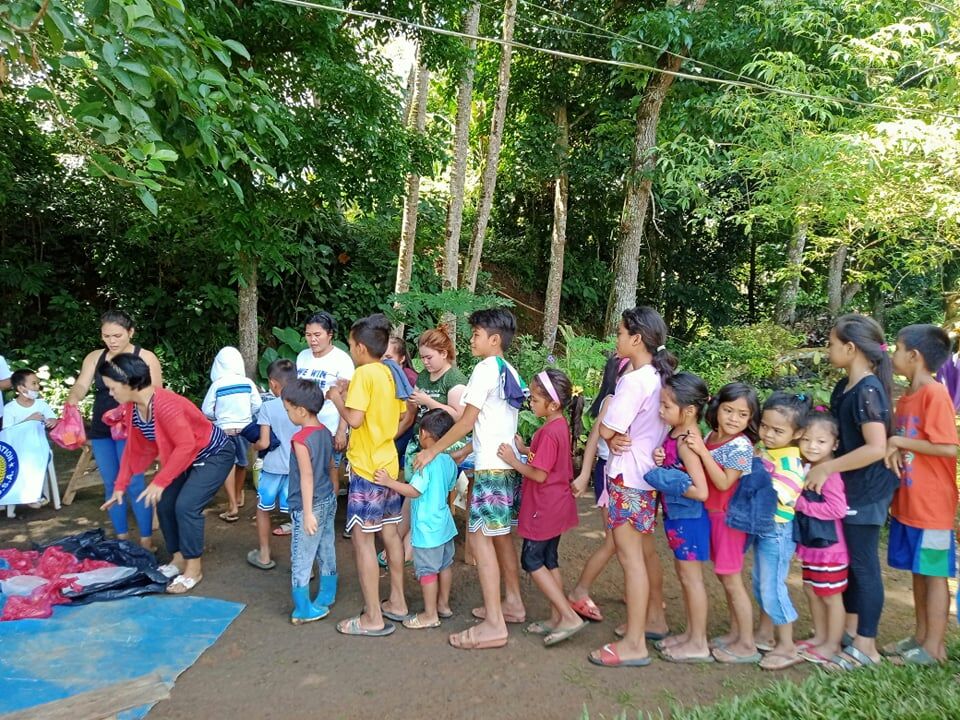 Residents in Parasan, Molave, Zamboanga del Sur line up during the distribution of clothes and toys.