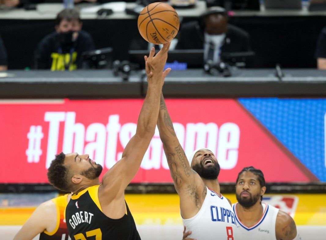 Utah Jazz center Rudy Gobert (27) and LA Clippers forward Marcus Morris Sr. (8) compete for a jump ball to start game five in the second round of the 2021 NBA Playoffs at Vivint Arena  in Salt Lake City on June 16, 2021.