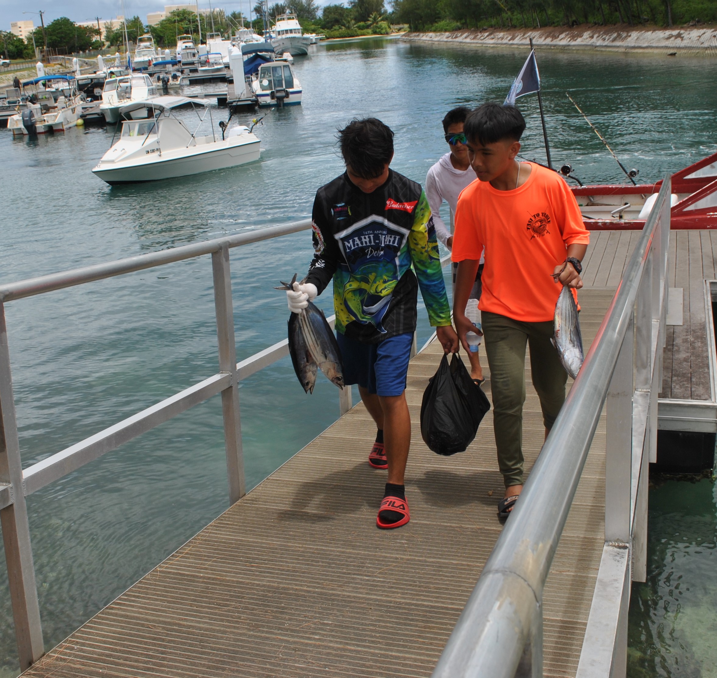 Tasi to Table students haul in their catch off the dock.