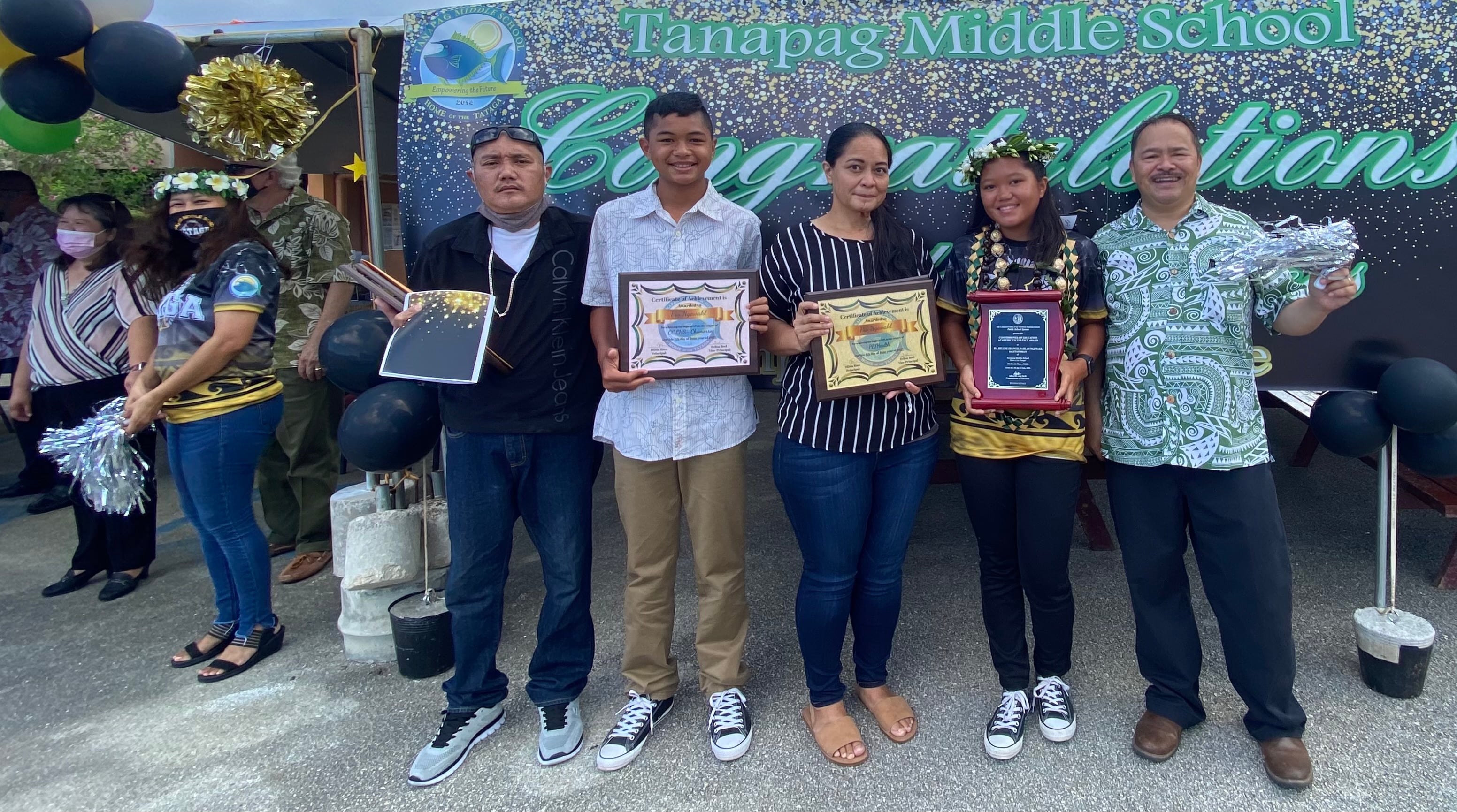 Salutatorian and Commissioner of Education awardee Pia Ngewakl poses with her family, Commissioner of Education Dr. Alfred B. Ada and school principal Hilda Rios.