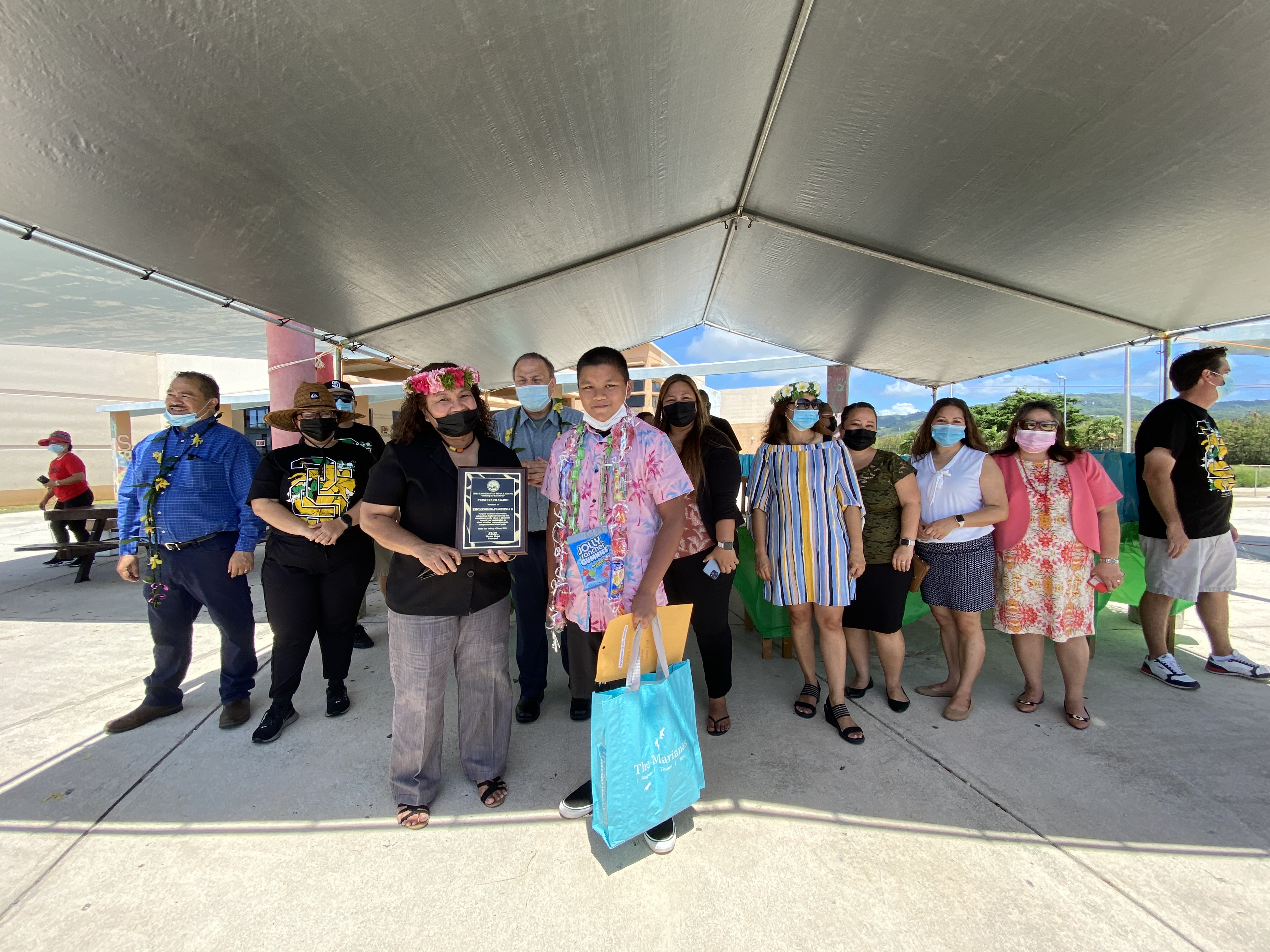 Third honor and the  recipient of the Principal’s Leadership Award,  Eric Manglona Pangelinan II, with school principal Martha Kintol.