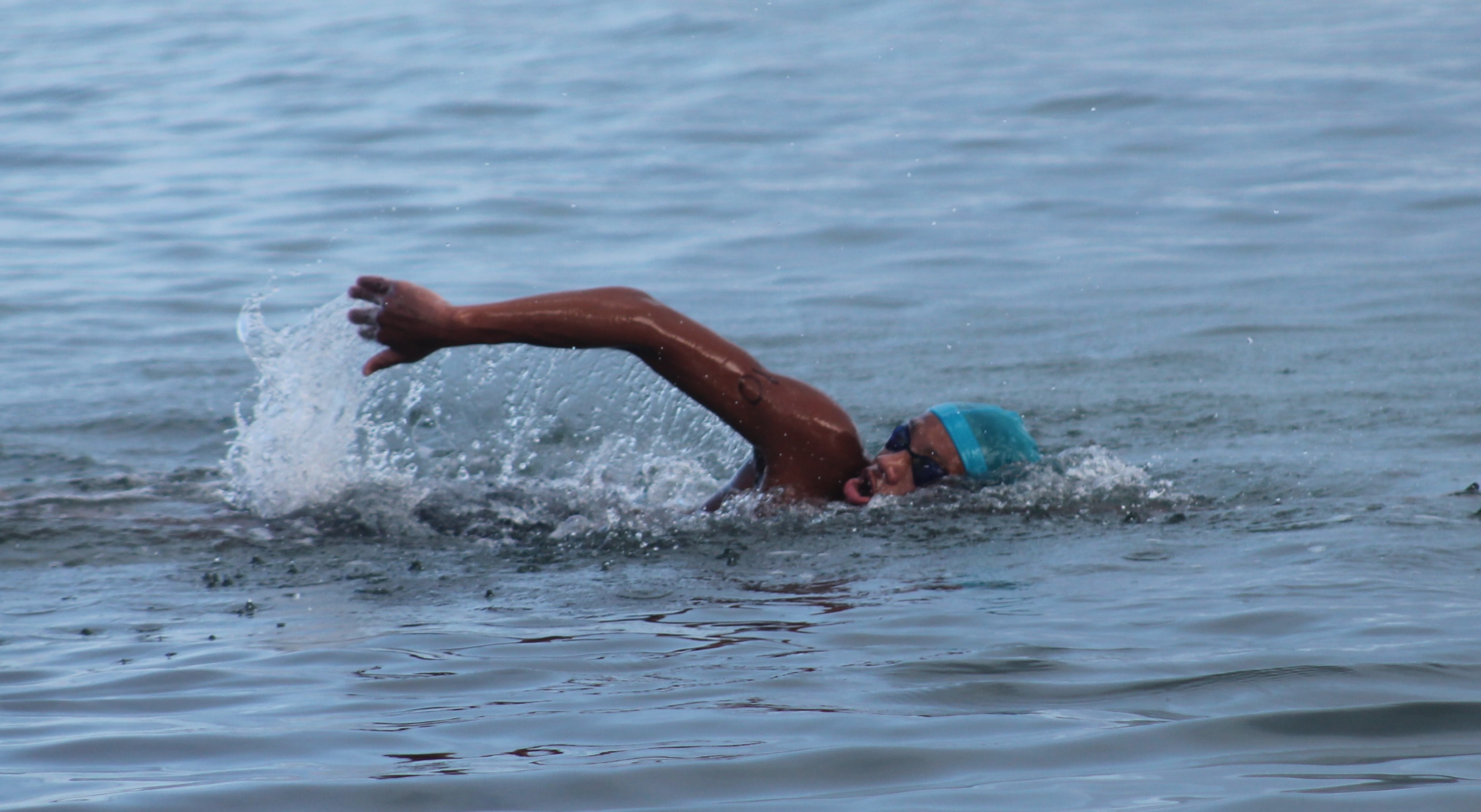 Isaiah Aleksenko gets some air as he  heads to the finish line in the 1500m distance race of the Triple Crown Open Water Swim Series on Saturday.