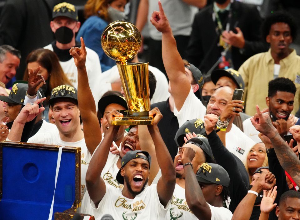 Milwaukee Bucks forward Khris Middleton (22) celebrates with the Larry O'Brien Trophy after game six of the 2021 NBA Finals and the championship against the Phoenix Suns at Fiserv Forum in Milwaukee, Wisconsin on July 20, 2021.