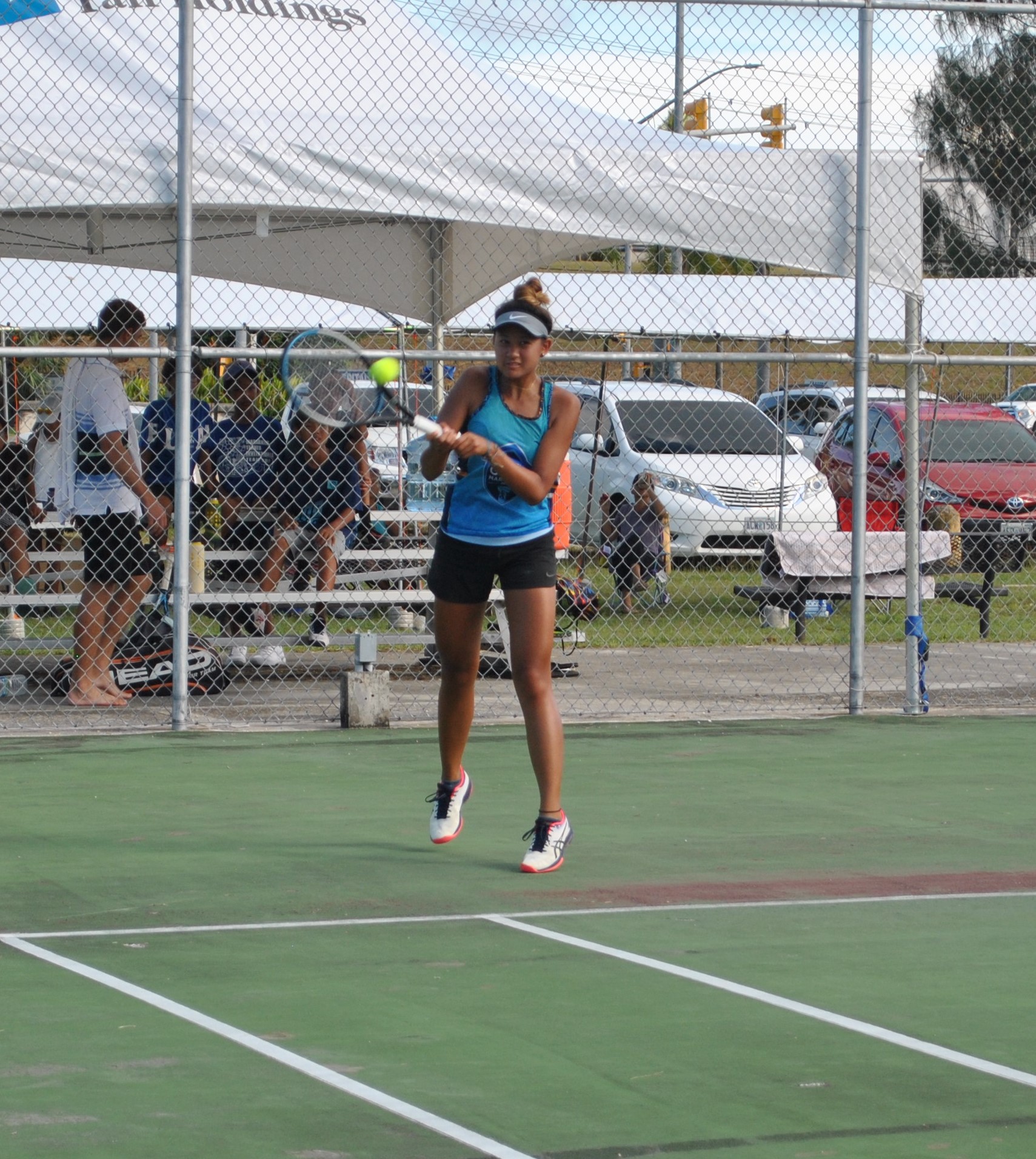 Tania Tan connects the two-hand return.