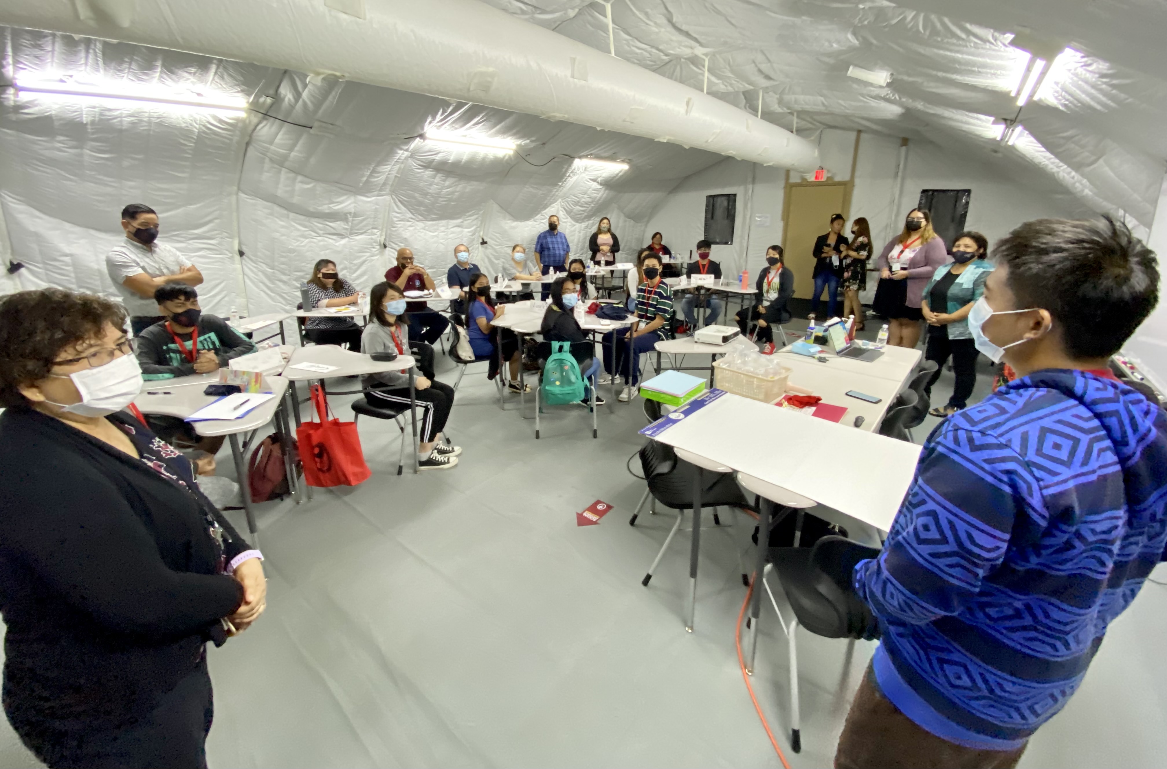 Public School System Curriculum and Instruction Senior Director Jackie Quitugua interacts with one of the students.