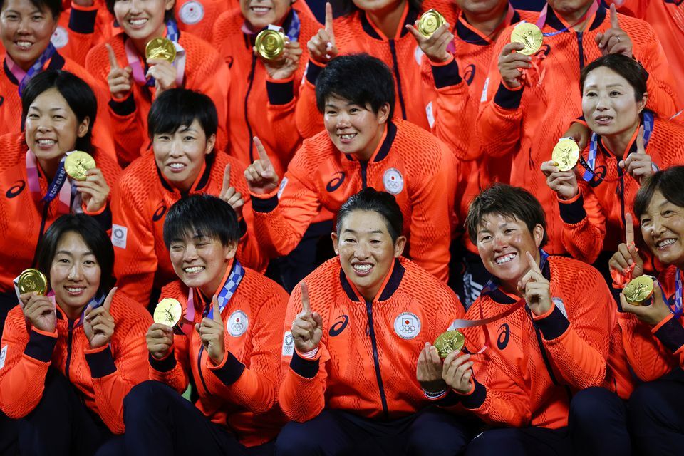 Japan’s softball players pose with their Olympic gold medals at the Yokohama Baseball Stadium in Yokohama, Japan on July 27, 2021.