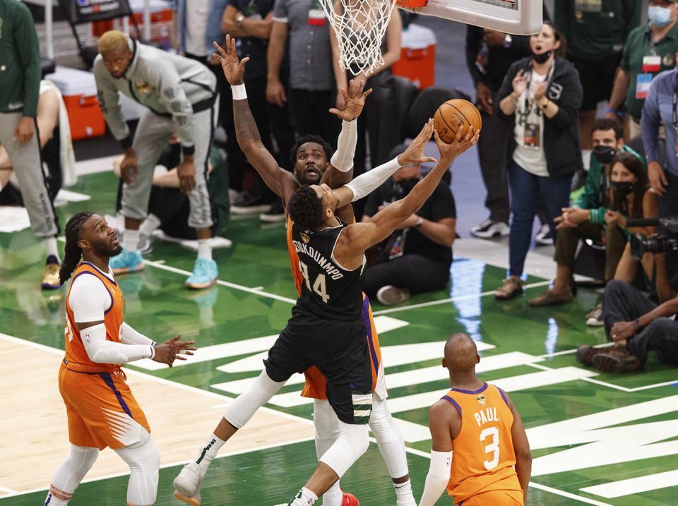 Milwaukee Bucks forward Giannis Antetokounmpo (34) shoots against Phoenix Suns center Deandre Ayton (22) during the fourth quarter during game six of the 2021 NBA Finals at Fiserv Forum in Milwaukee, Wisconsin on July 20, 2021.