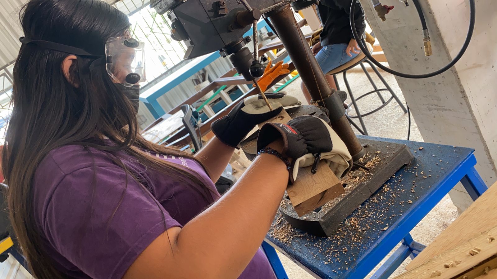 An eighth grader tries her hands at woodworking.
