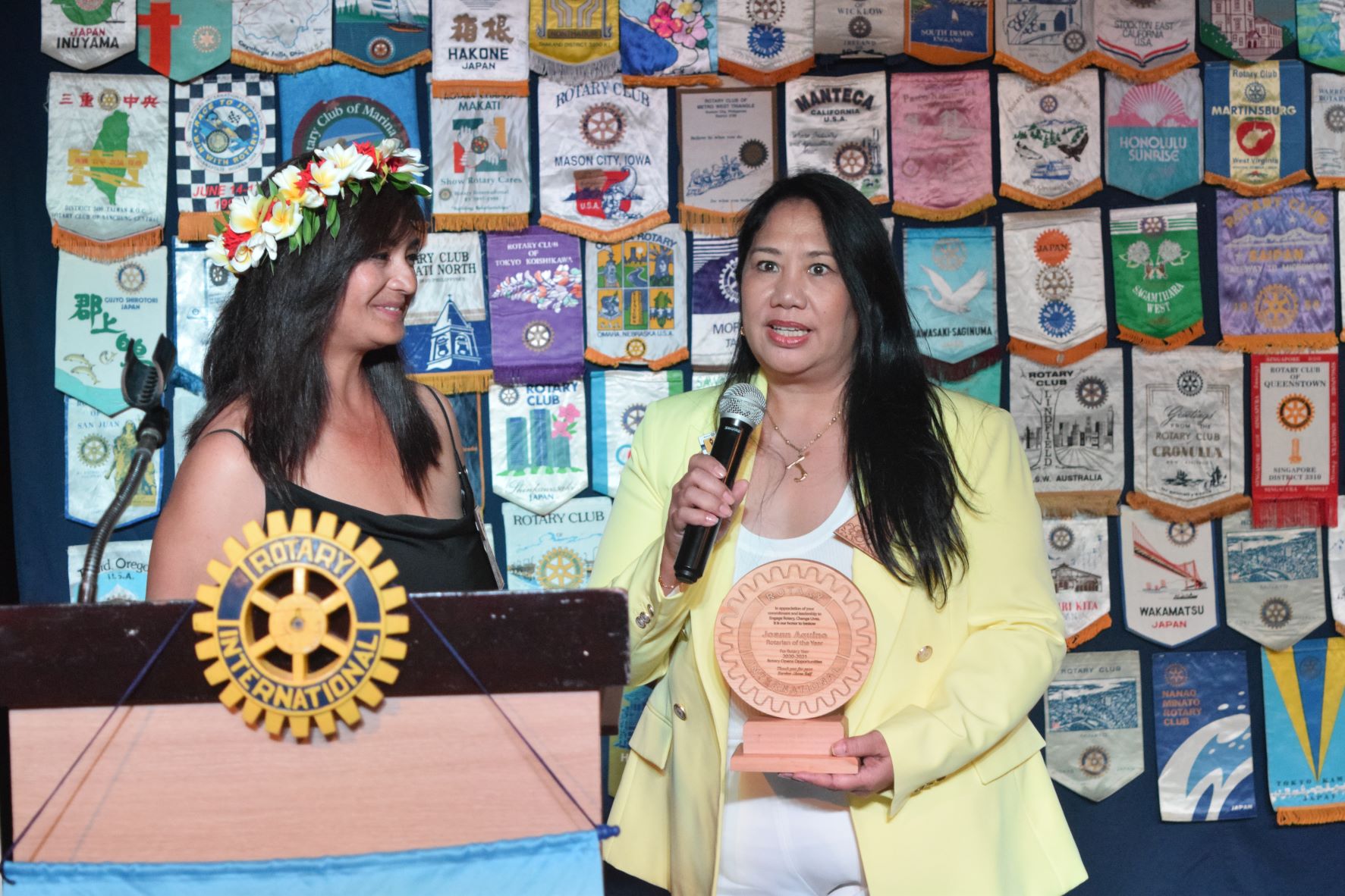 Rotary of the Year awardee Joann Aquino, right, speaks as outgoing club president Sonya Dancoe looks on.