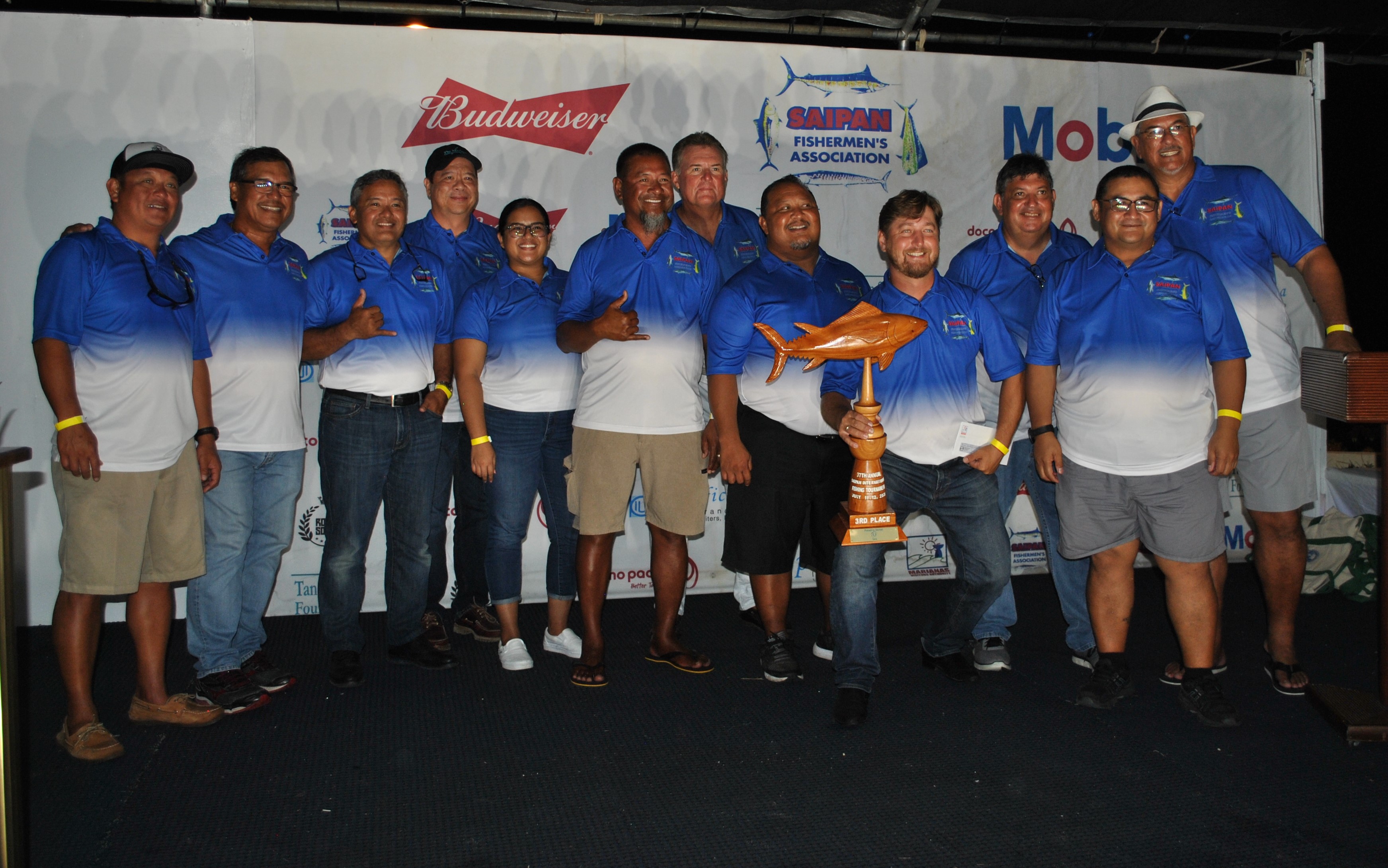 The Saipan Fishermen's Association officers and members pose for a photo before presenting a trophy.
